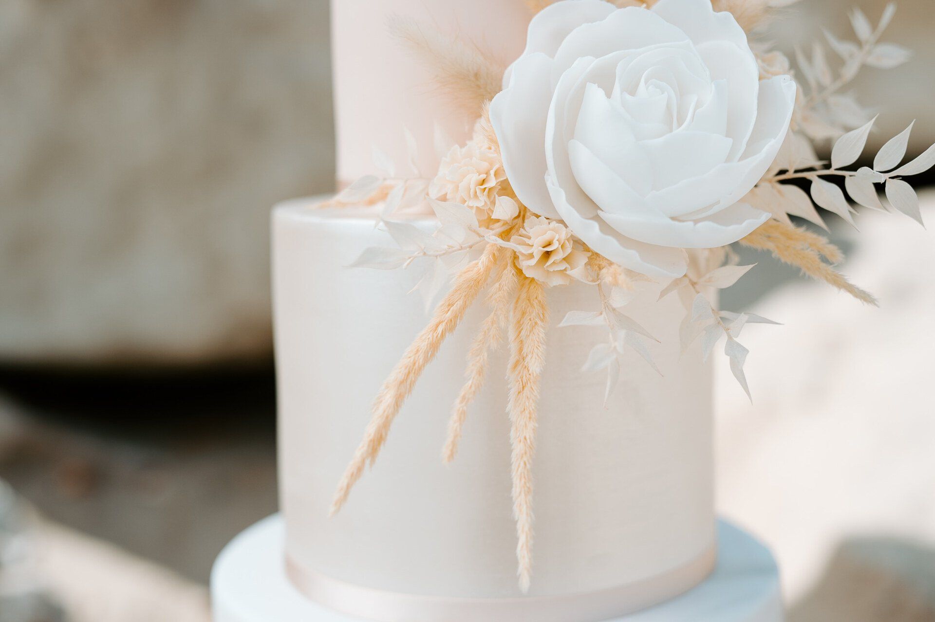 Close up detail of a wedding cake on the beach at Highcliffe Beach in Dorset