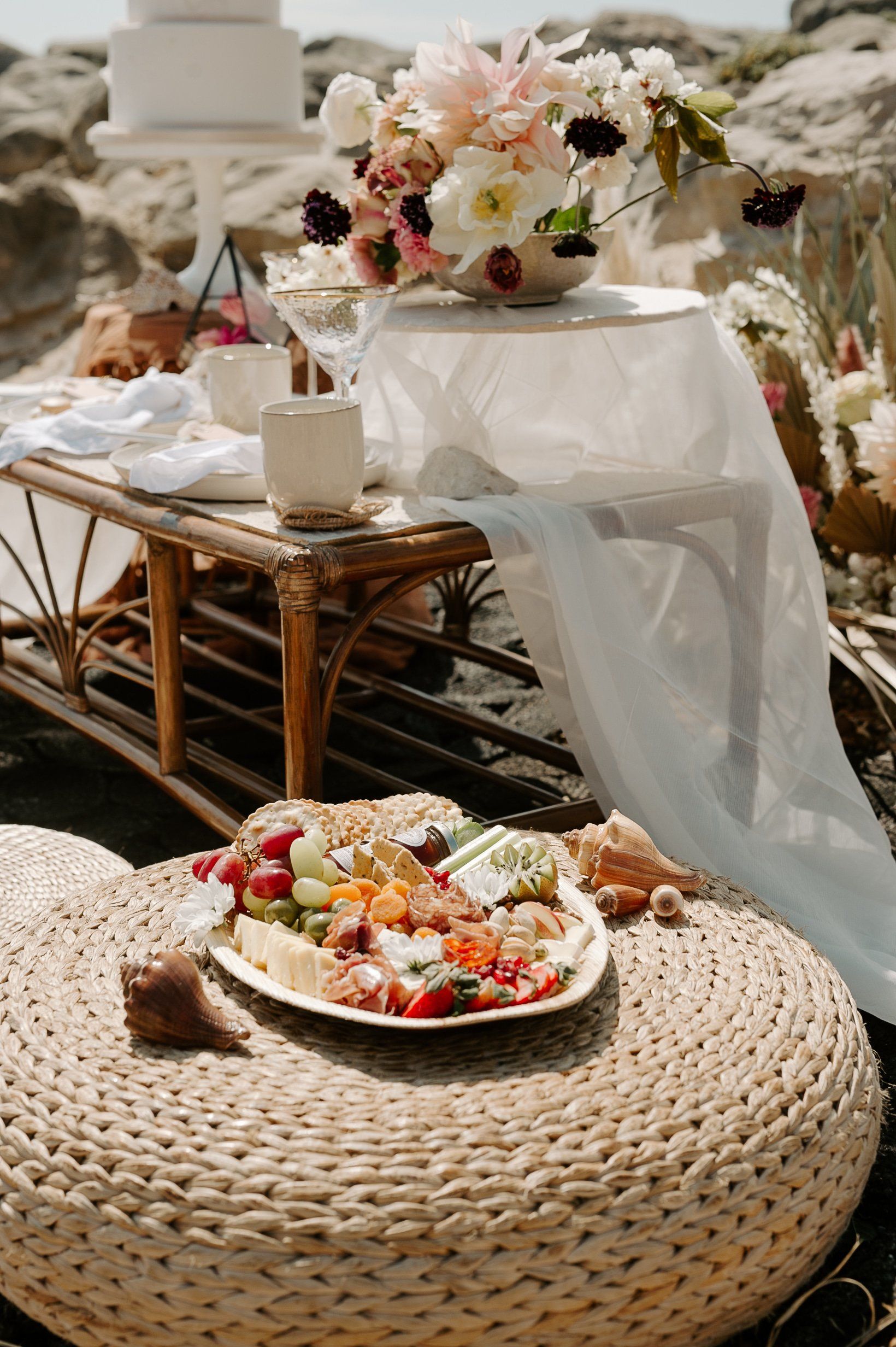 Grazing platter picnic on a wicker stool on Highcliffe Beach in Dorset
