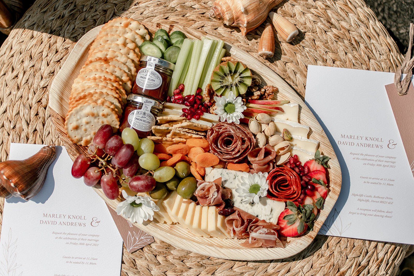 Grazing Platter on a wicker footstool with wedding stationery and seashells decorating it