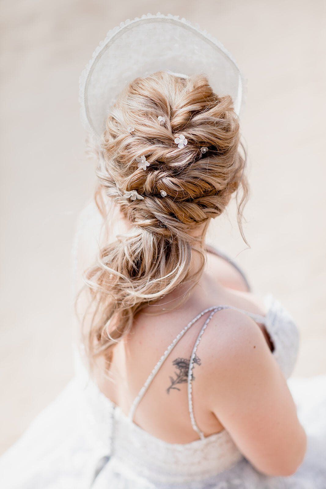 Back of brides hairdo with pearl flowers in