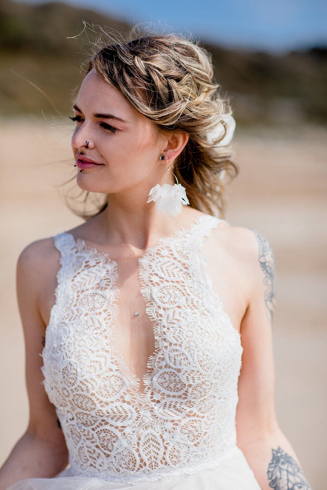 Close up of boho bridal hairstyle on bride wearing wedding dress on Highcliffe Beach in Dorset