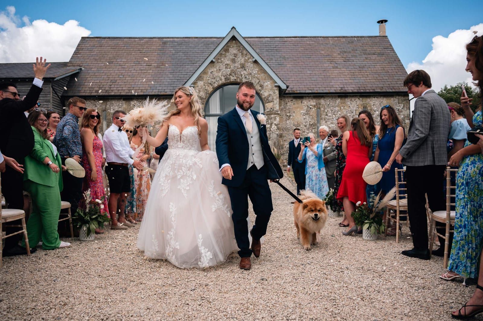 Bride and groom walking with the dog up the aisle co-ordinated by Tasha Mae Wedding Co-ordinator