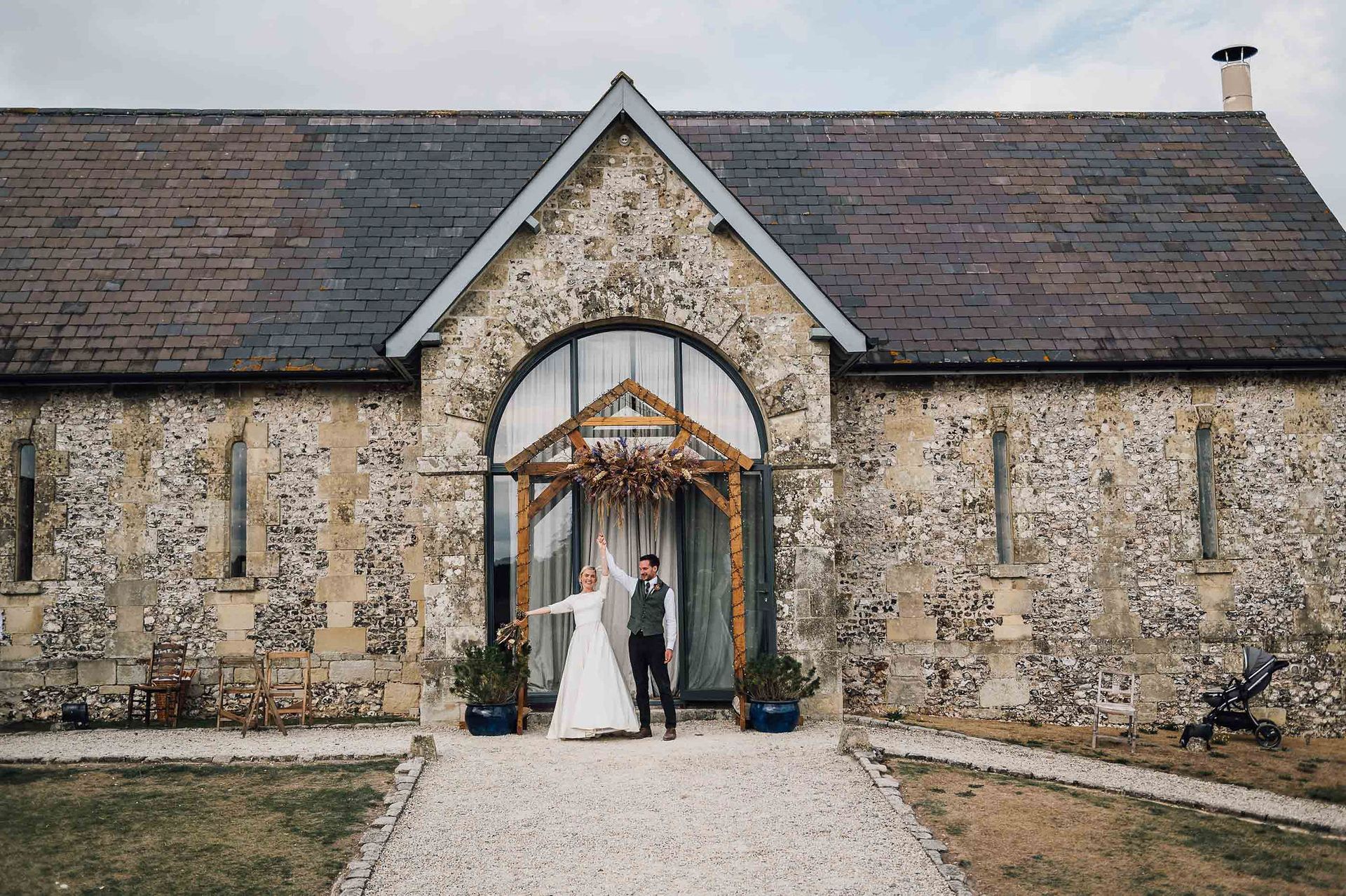 Bride and groom stood outside Bake Barn wedding venue on Fonthill Estate in Wiltshire - co-ordinator Tasha Mae Wedding Co-ordinator.