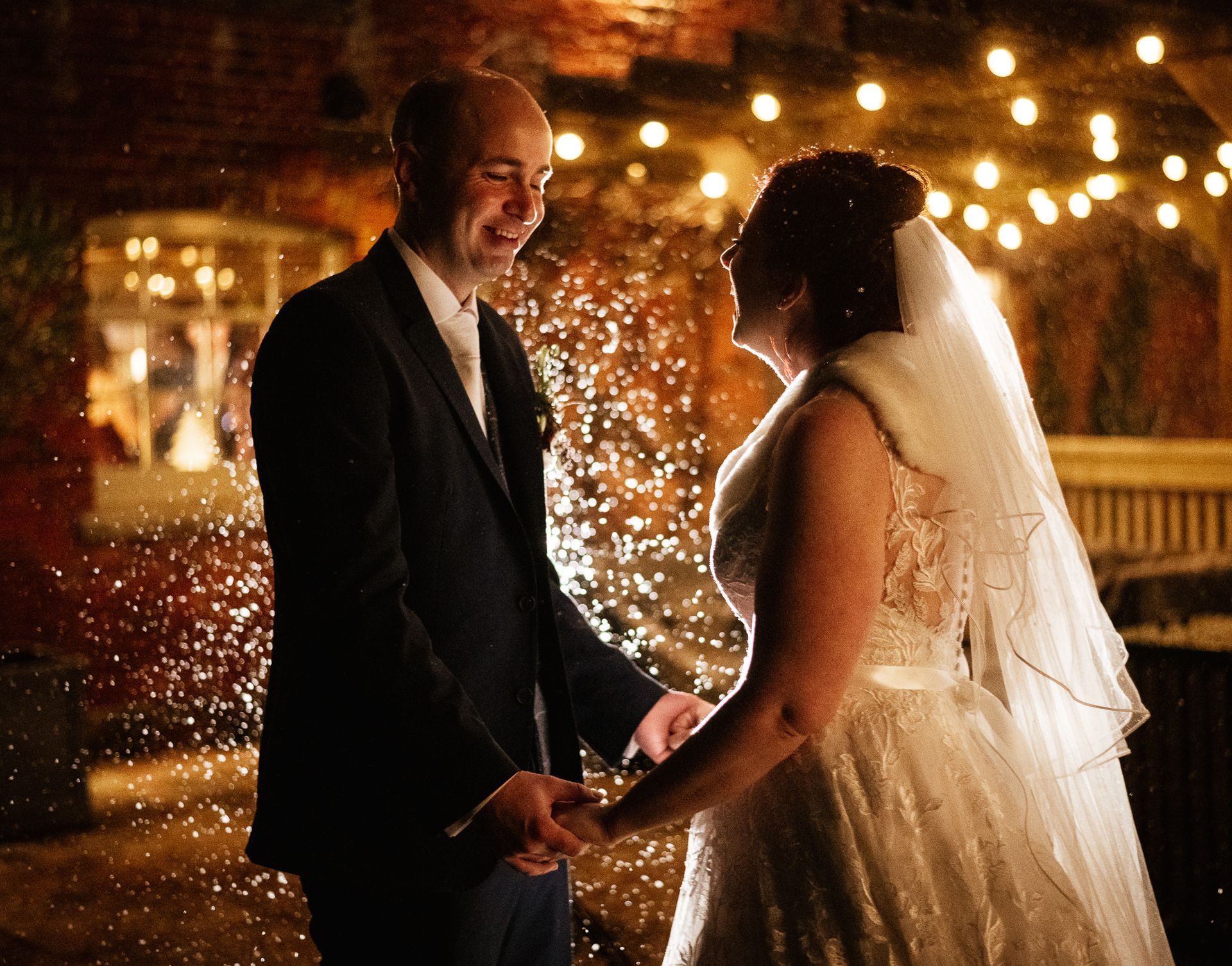 Bride and groom under a snow machine at a wedding at Sopley Mill with Tasha Mae Wedding Co-ordinator.