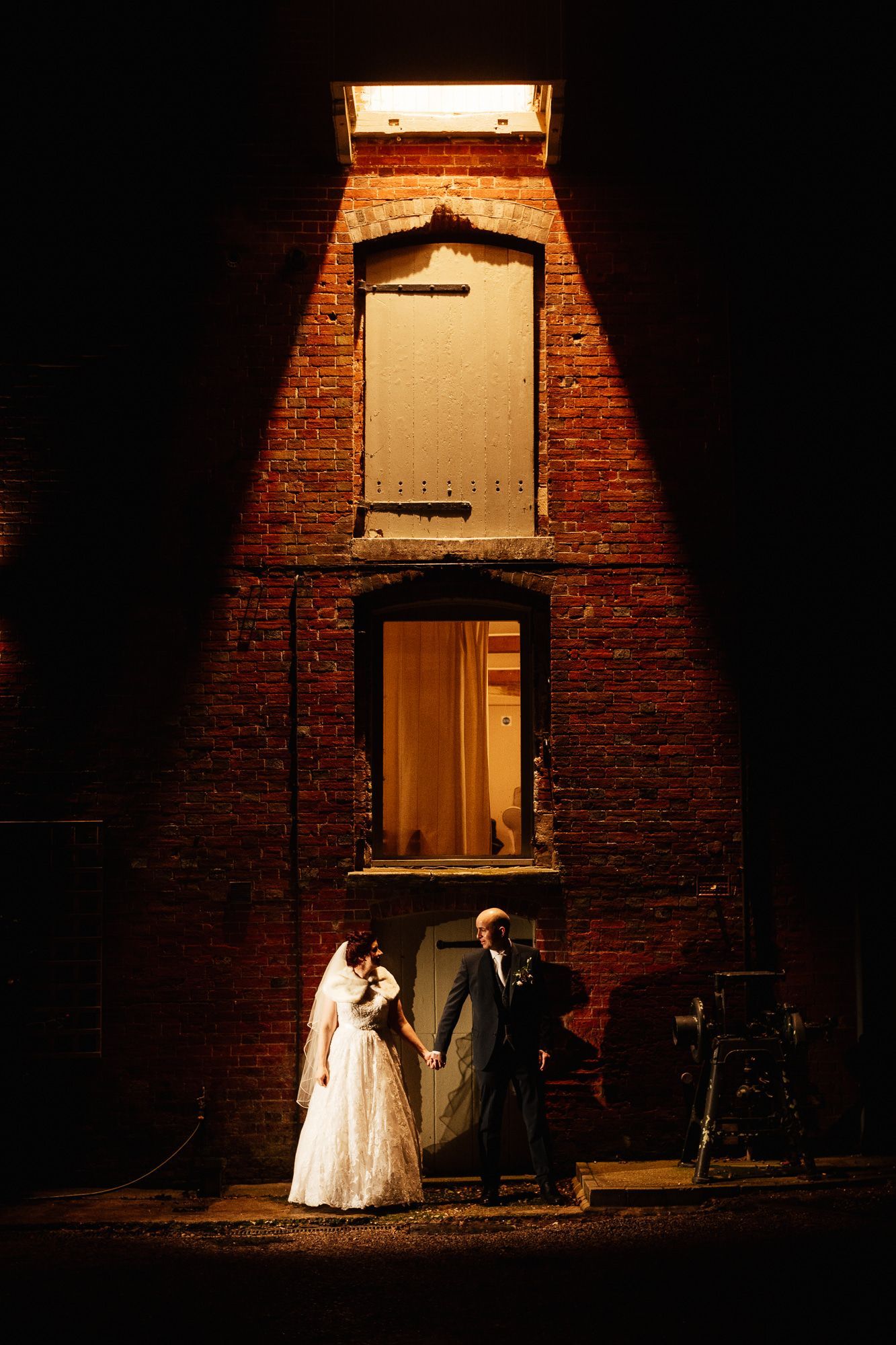 Bride and groom stood in front of Sopley Mill wedding venue by night with Tasha Mae Wedding Co-ordinator.