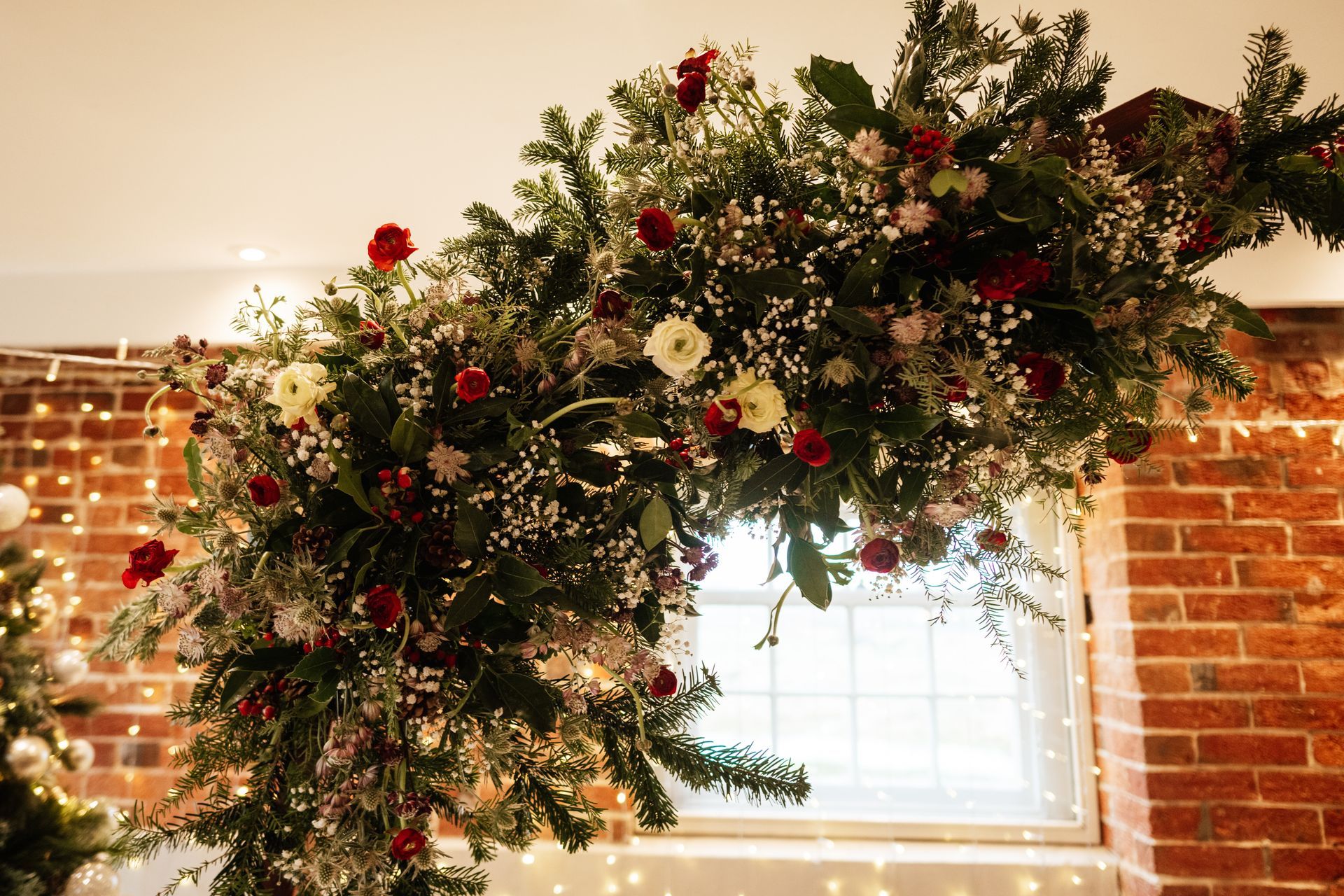 Christmas themed wedding florals and foliage at a wedding at Sopley Mill with Tasha Mae Wedding Co-ordinator.