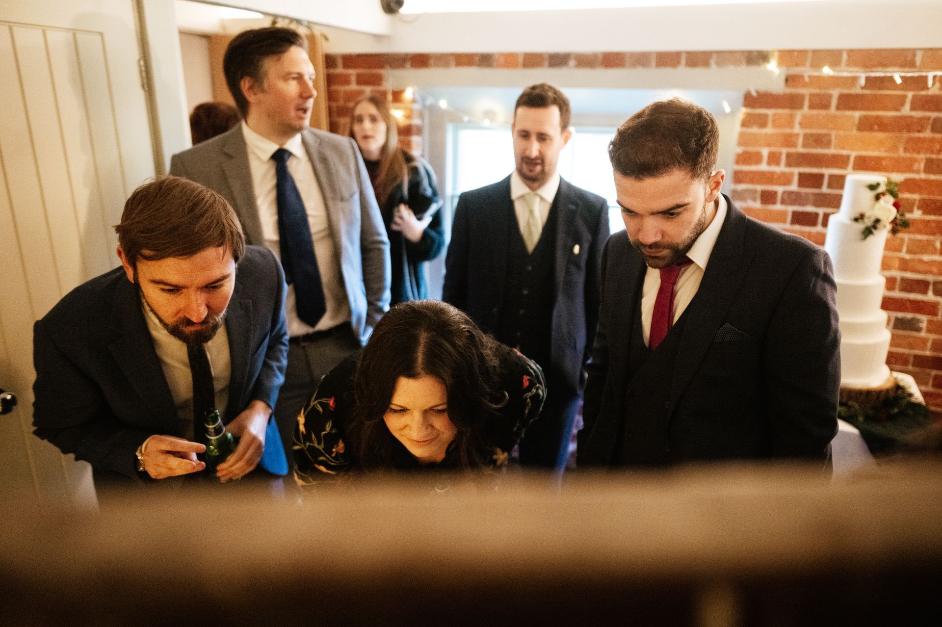 Guests looking at a wedding table plan at a wedding at Sopley Mill with Tasha Mae Wedding Co-ordinator.