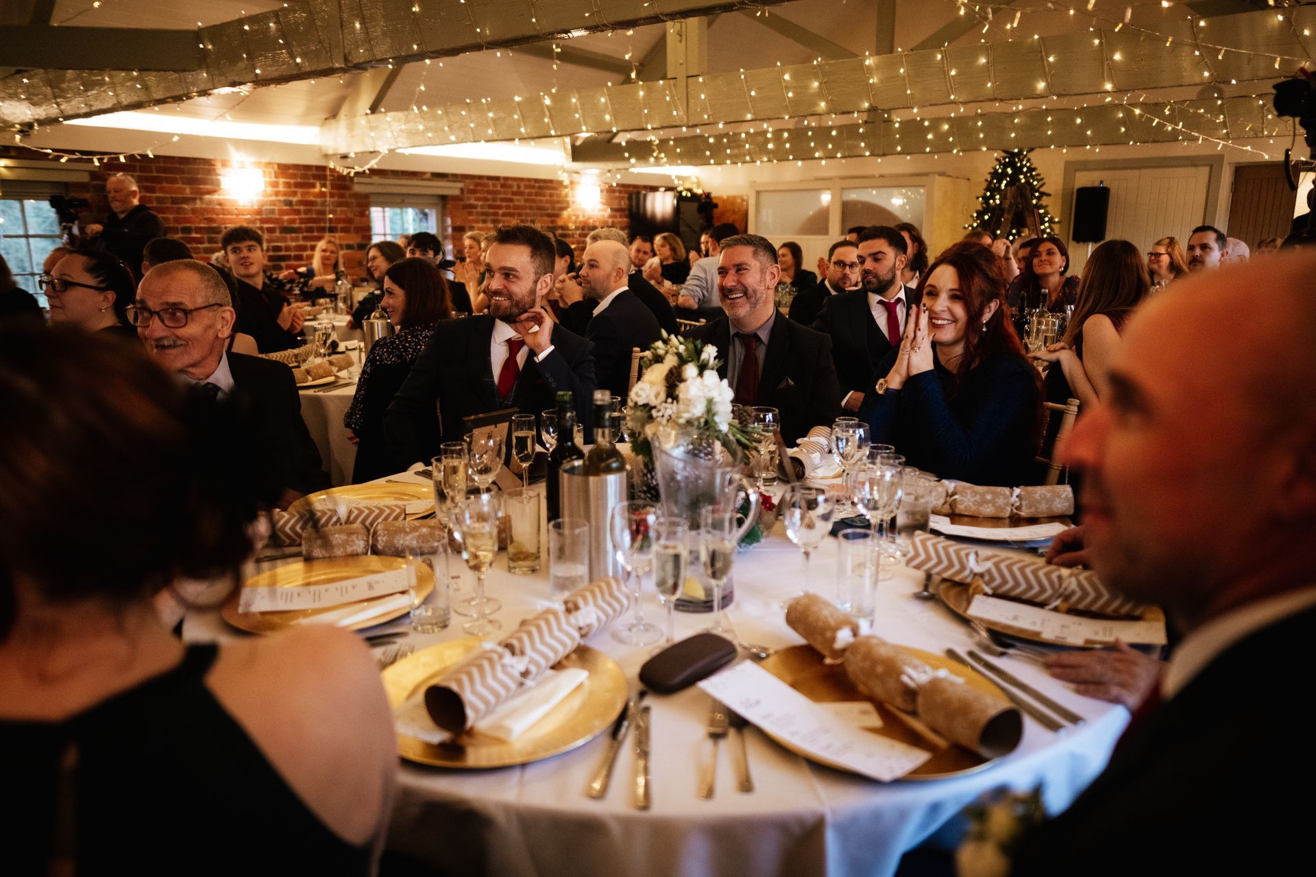 Wedding guests laughing at the speeches at a wedding at Sopley Mill with Tasha Mae Wedding Co-ordinator.