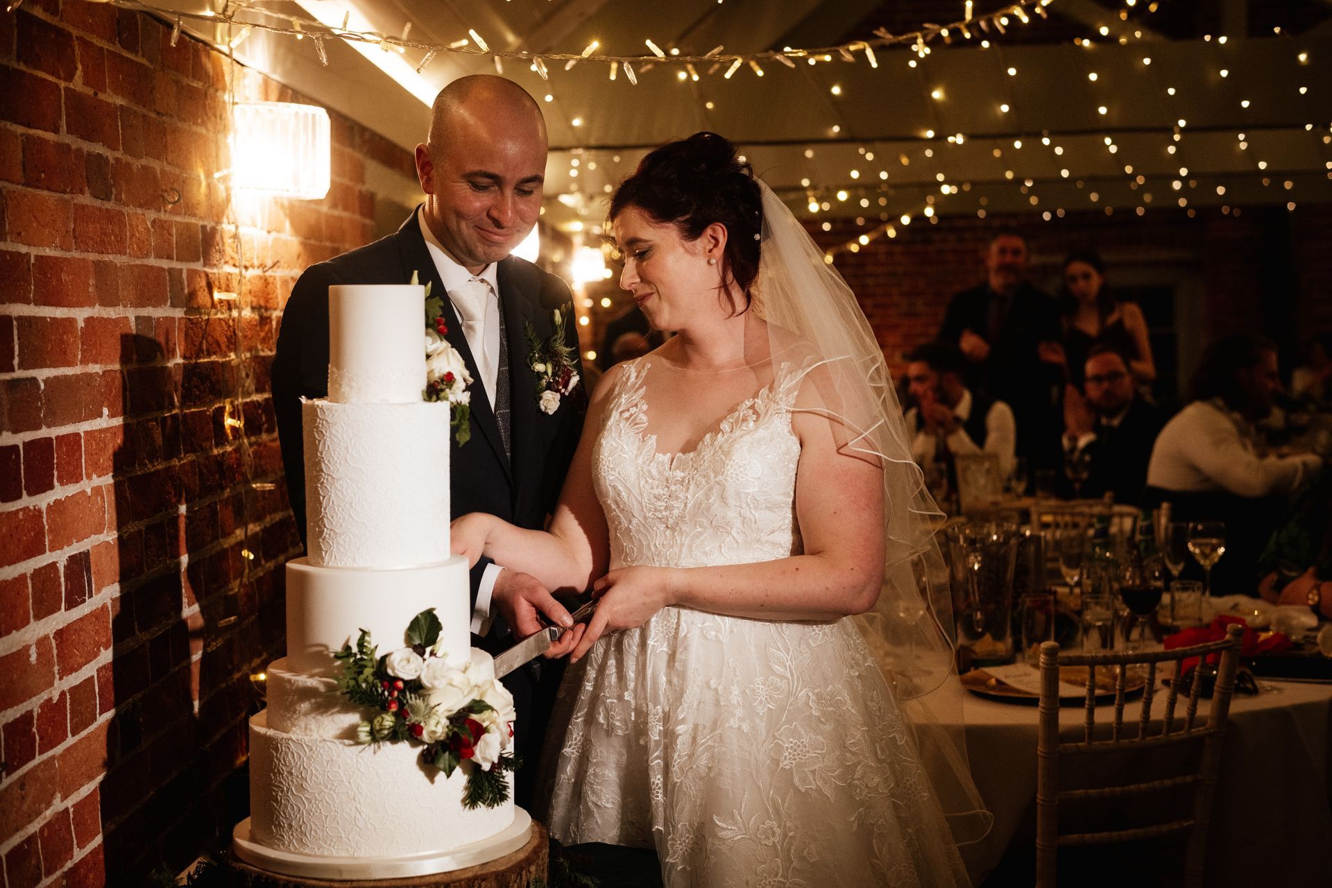 Bride and groom cutting their wedding cake at a wedding at Sopley Mill with Tasha Mae Wedding Co-ordinator.