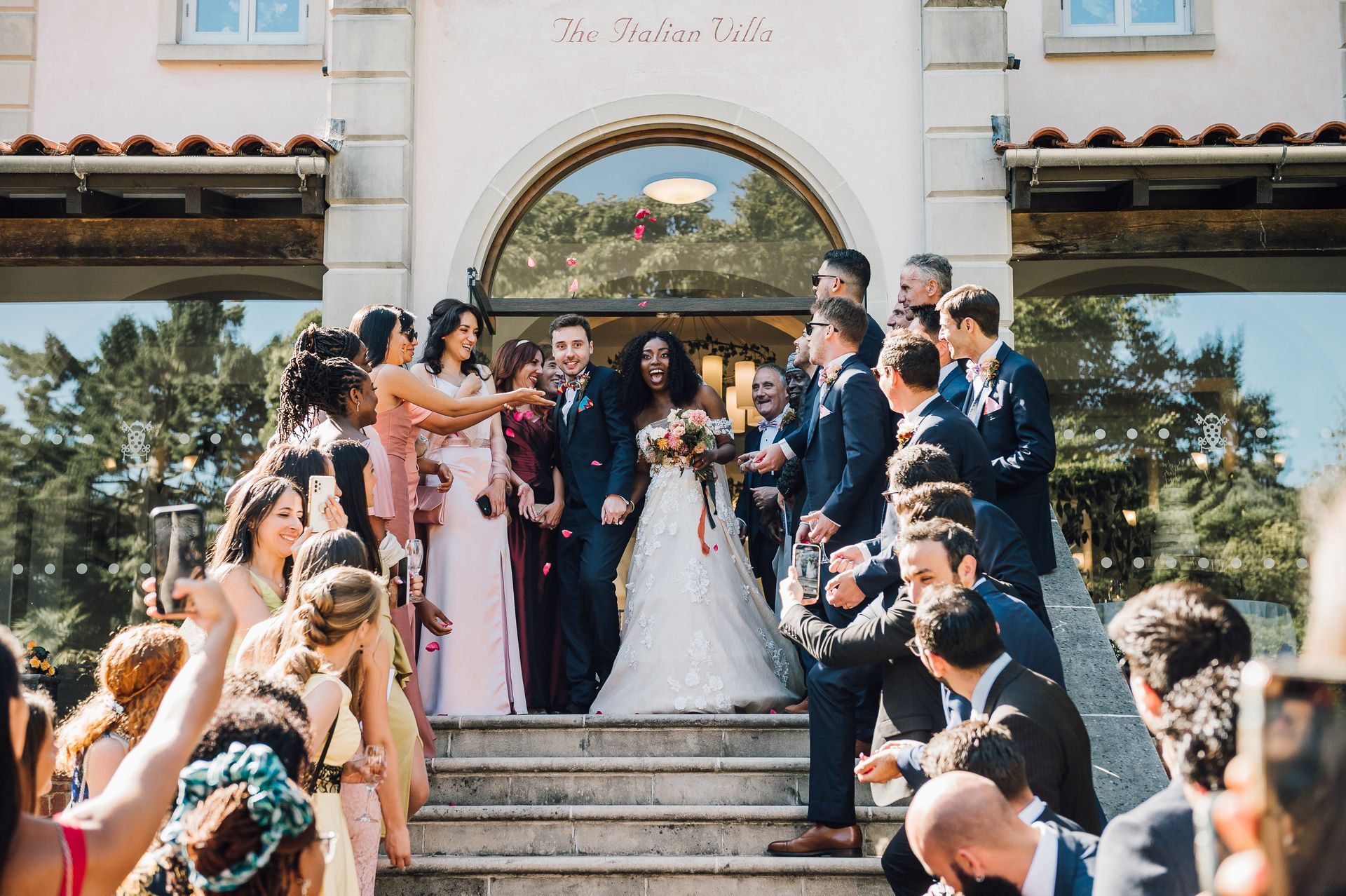 Bride and groom walking down steps at The Italian Villa in Canford Cliffs, Dorset - Co-ordinated by Tasha Mae Wedding Co-ordinator.