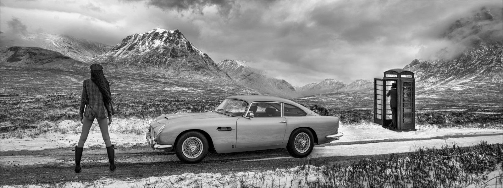 Black and white photograph of Glencoe Scotland with female model, James Bond Aston Martin and phone box, by David Yarrow