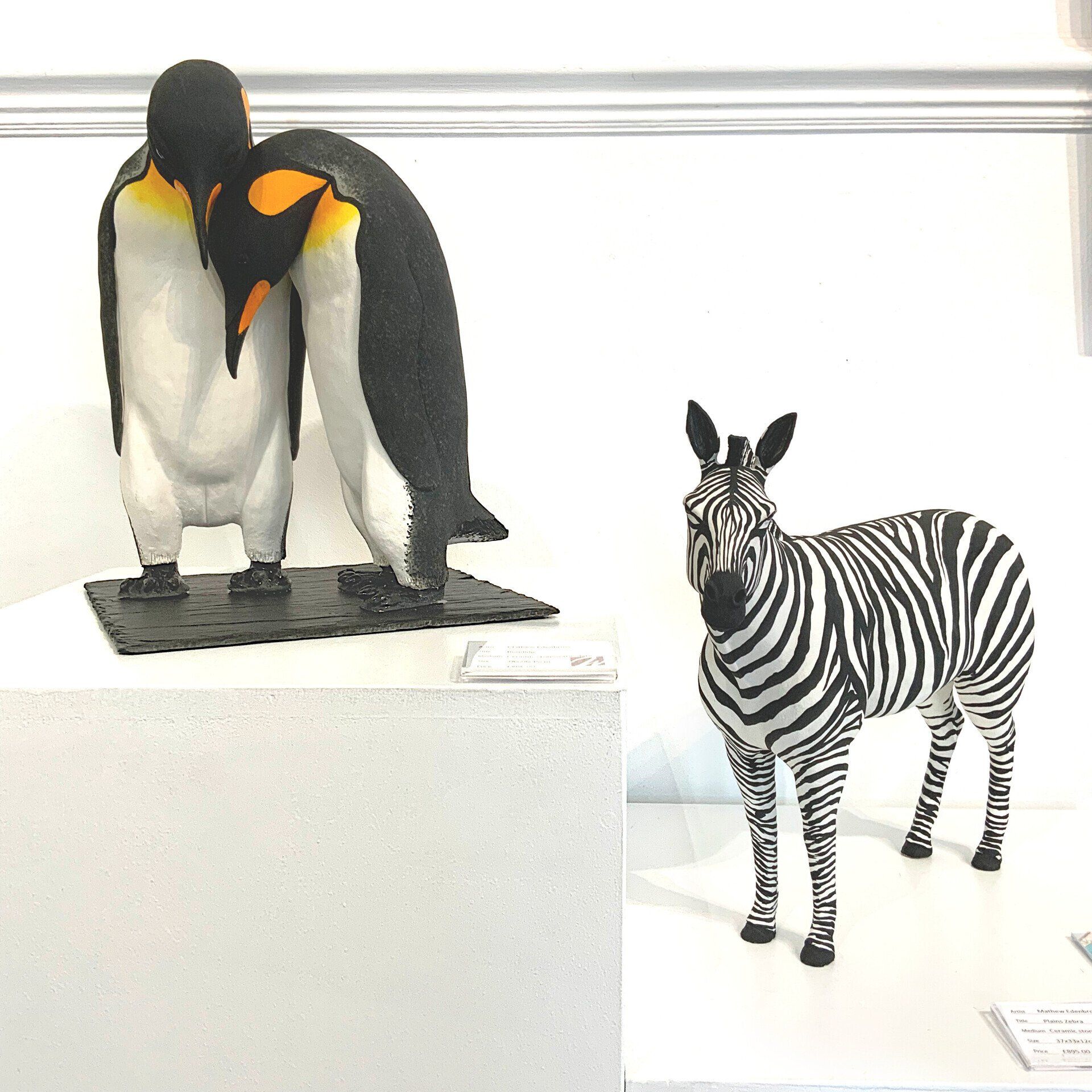 Sculpture of penguin couple and sculpture of zebra by Mathew Edenbrow at Watson Gallery Edinburgh