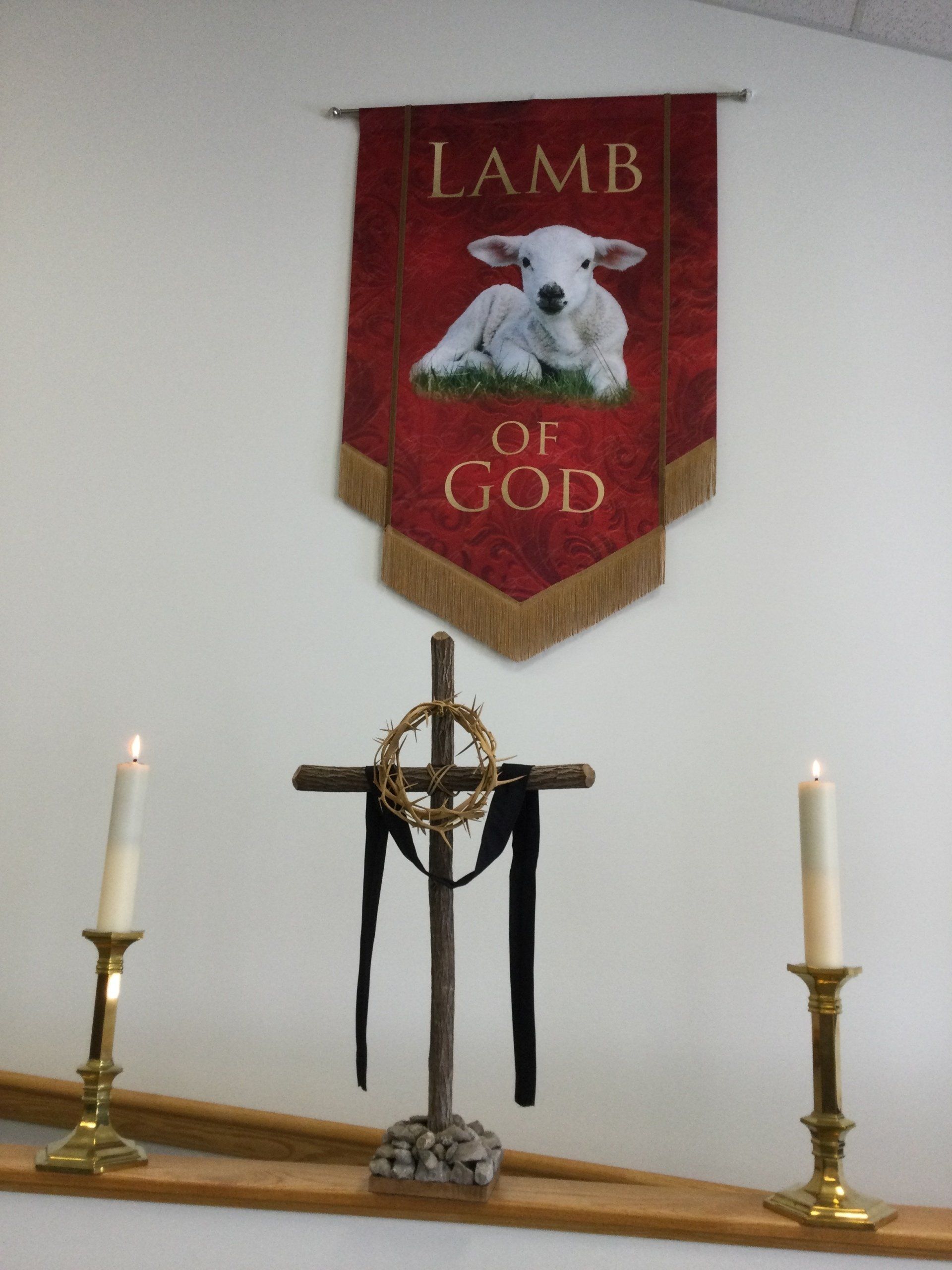 Cross, candles, Lamb of God Banner in Church