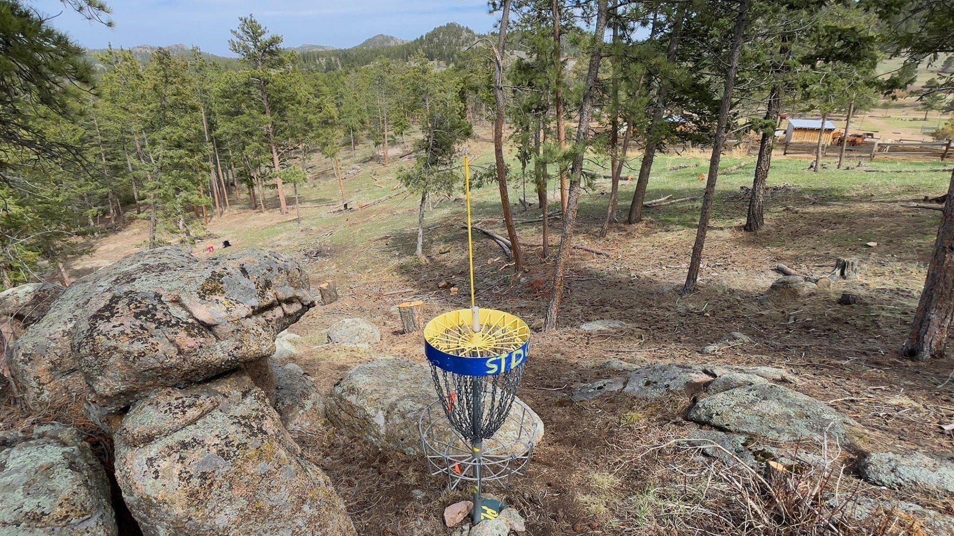 New disc golf hole 3 basket looking back down the fairway at Sundance Trail Guest Ranch May 2022
