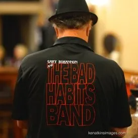 Gary Bohannon wearing a Bad Habits band shirt, seen from the back