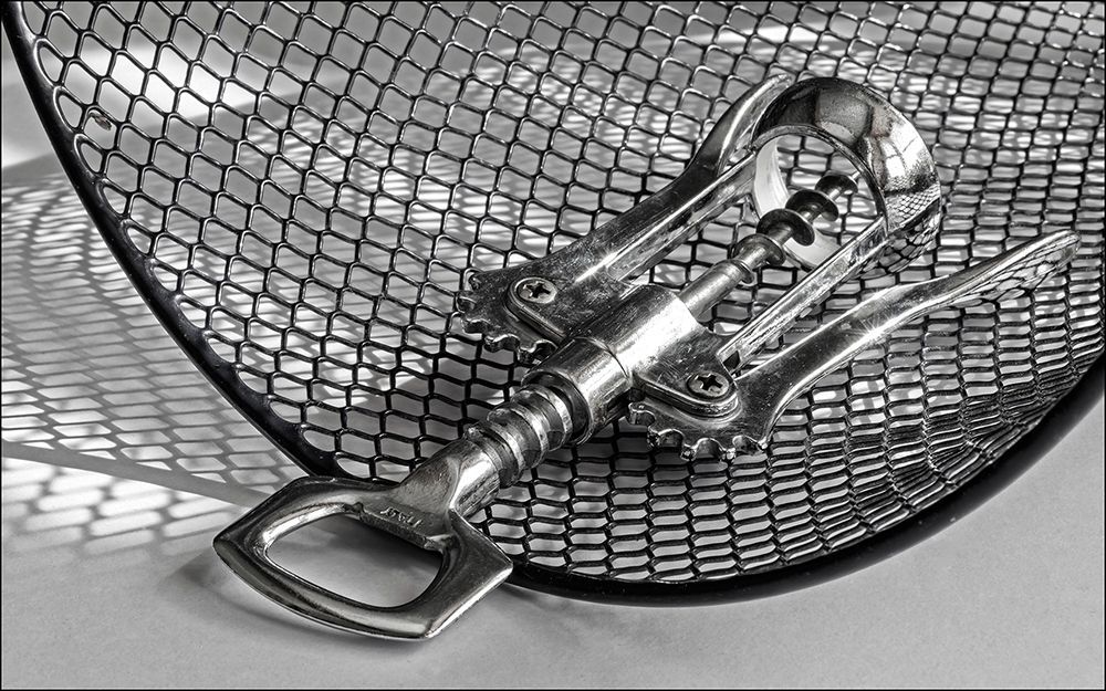 A monochrome image of a bottle opener