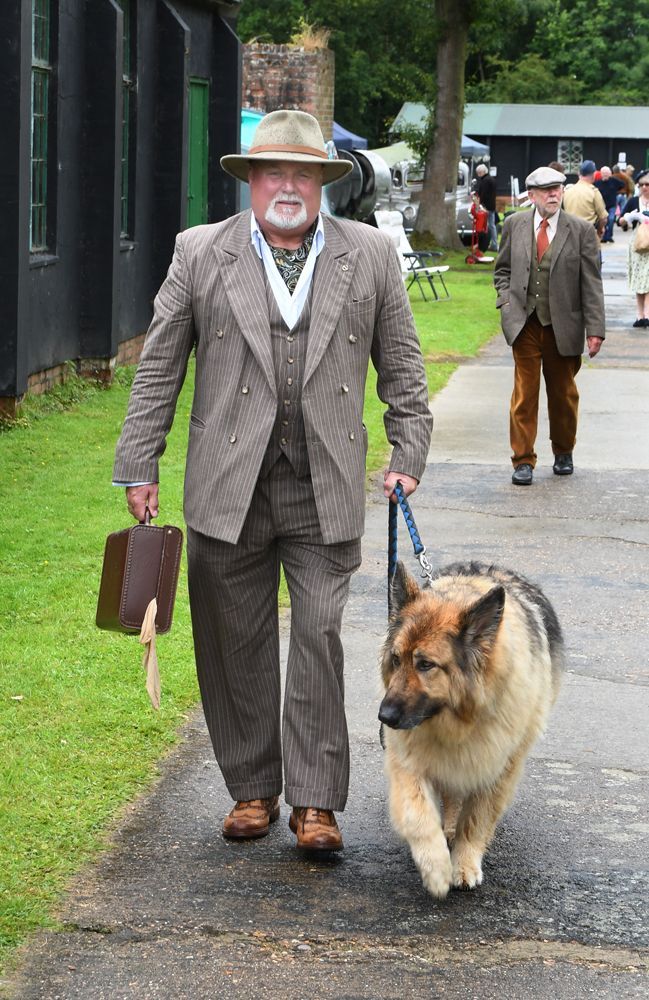 a man dressed in a 1940s style role playing as a salesman