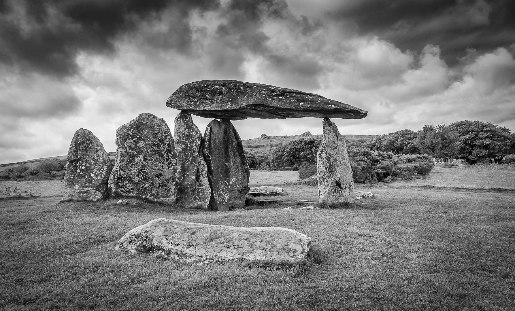 a monochrome image of standing stones in wales