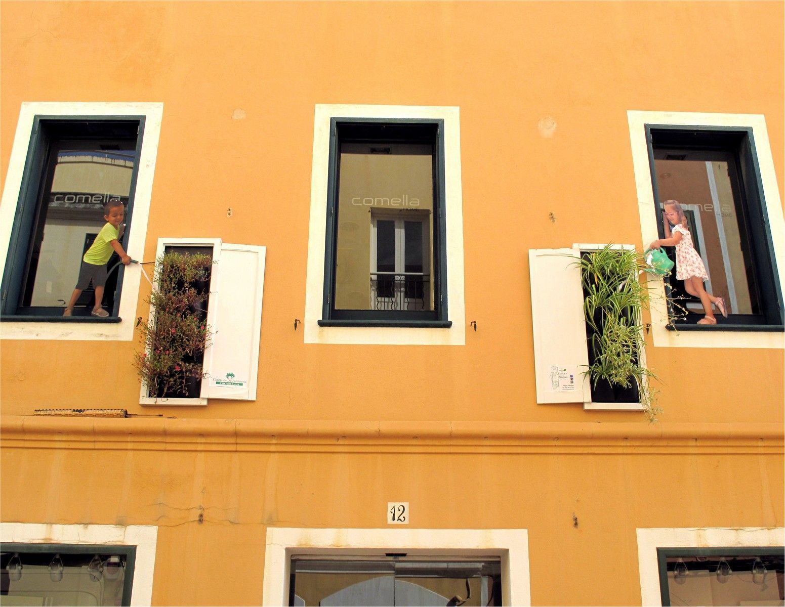 photos of children on the side of a building