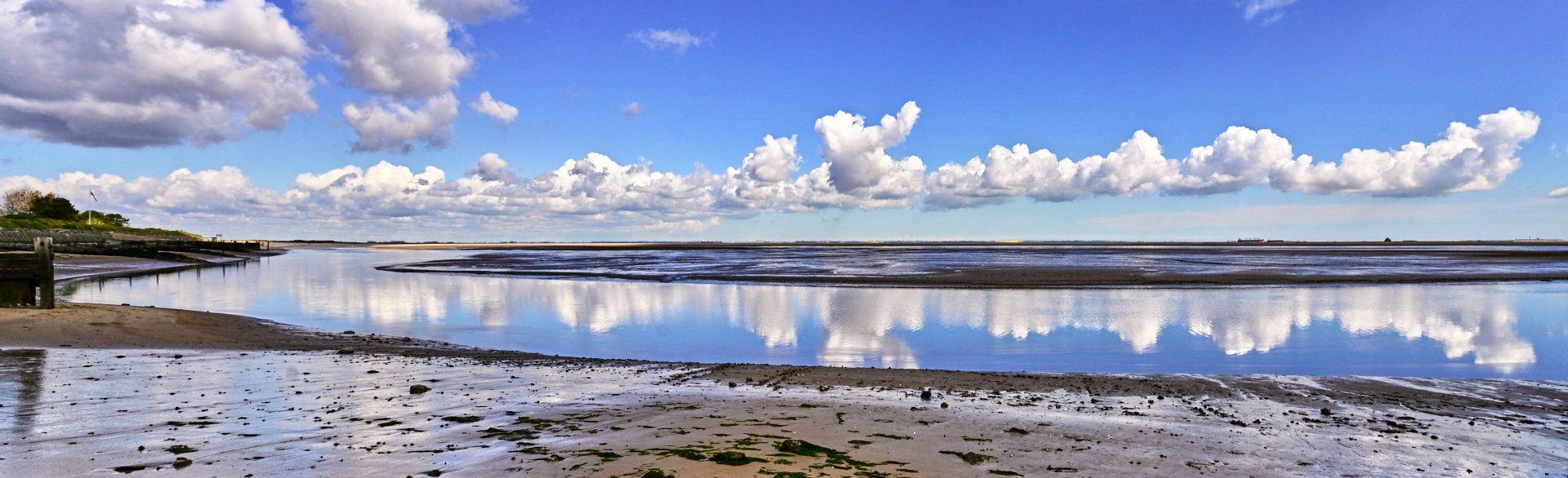 clouds reflected in the water of humberston fitties beach