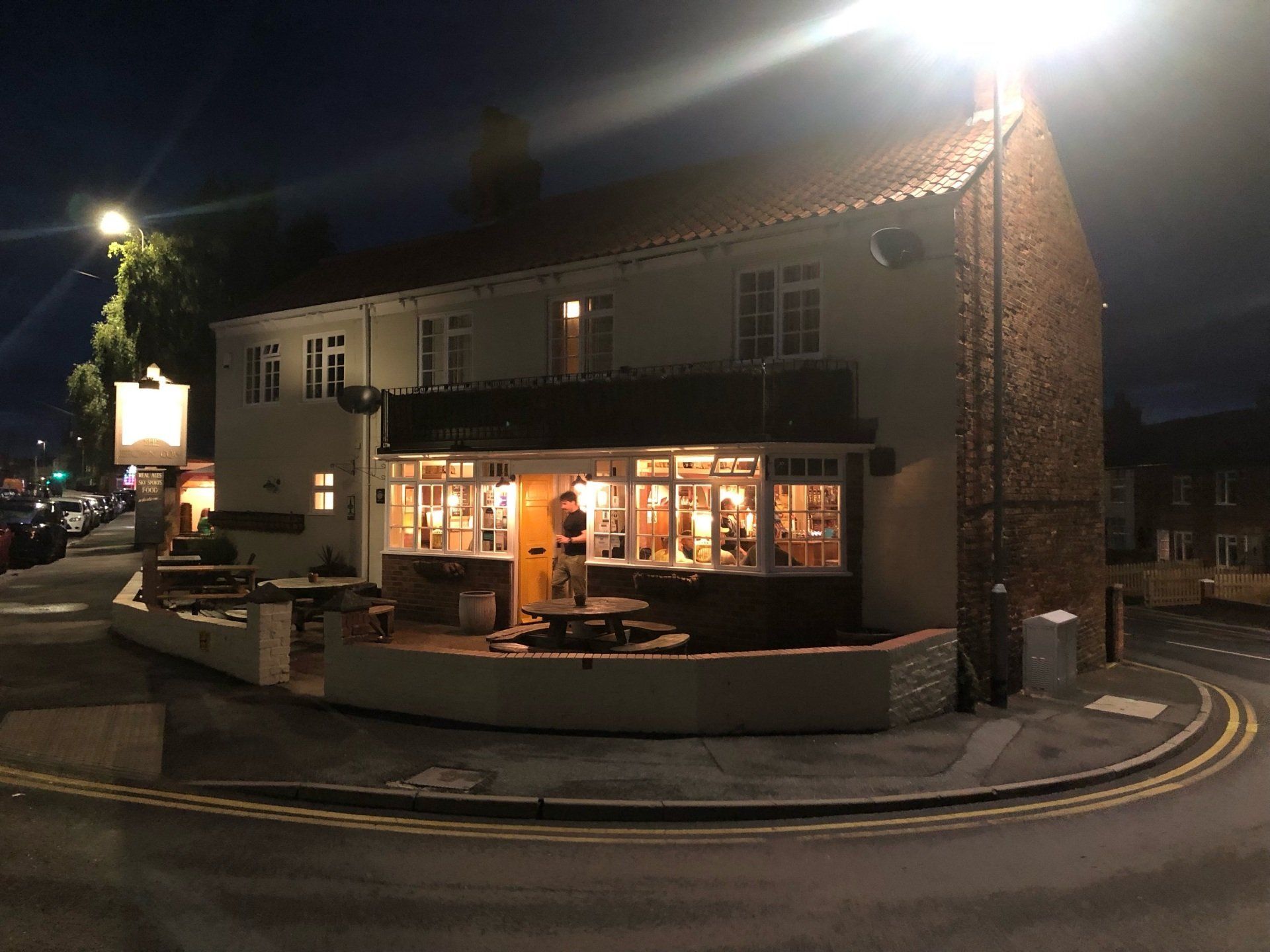 an exterior view of a pub at night