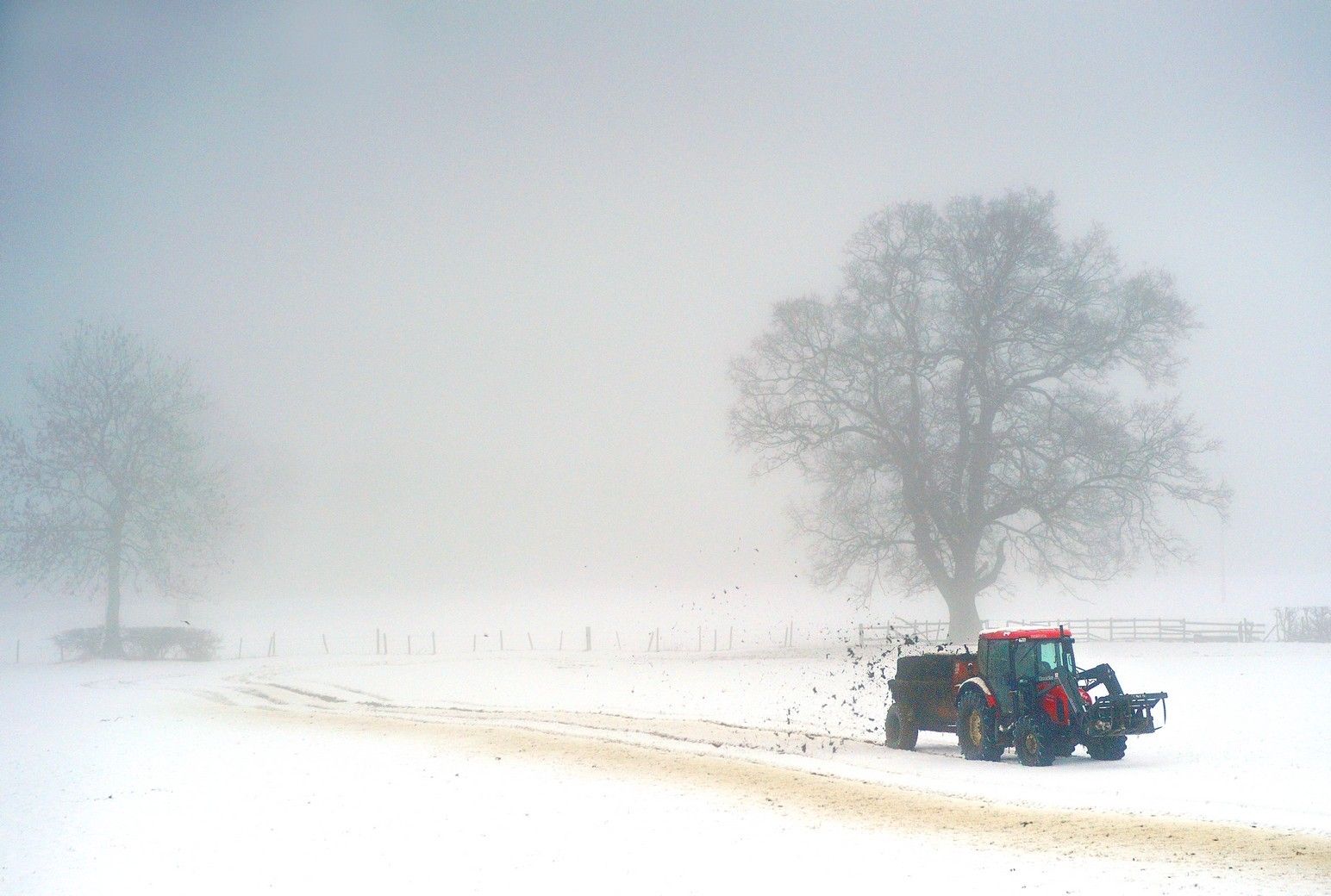 A farm tractor in a snowy field