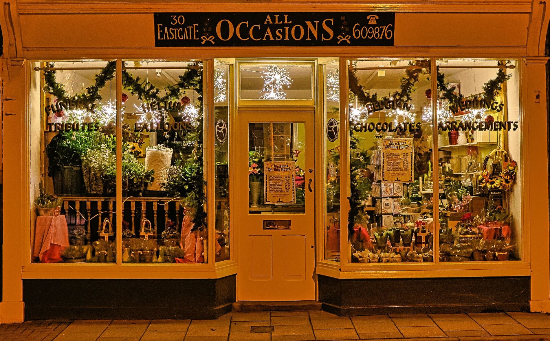 a night time view of the All Occasions shop front