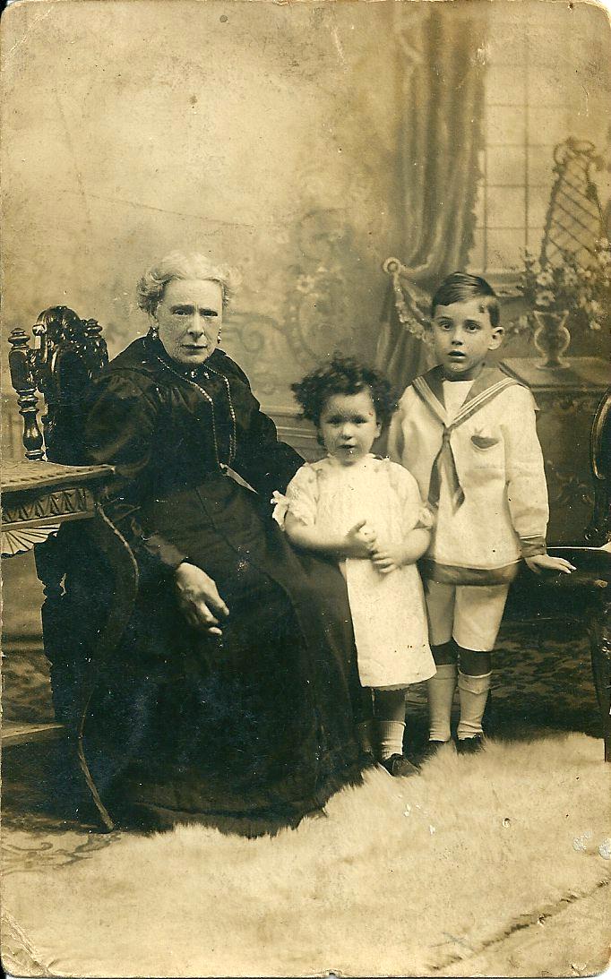 a portrait of a woman with two children early 20th century
