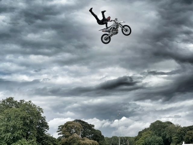an airborne acrobatic motor bike rider