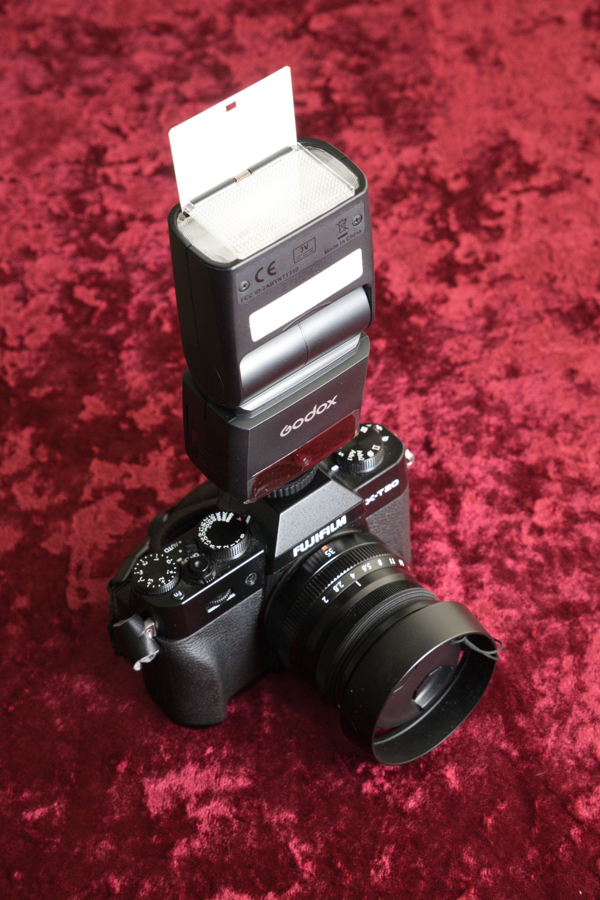a photograph of a camera, and hot shoe mounted flash
