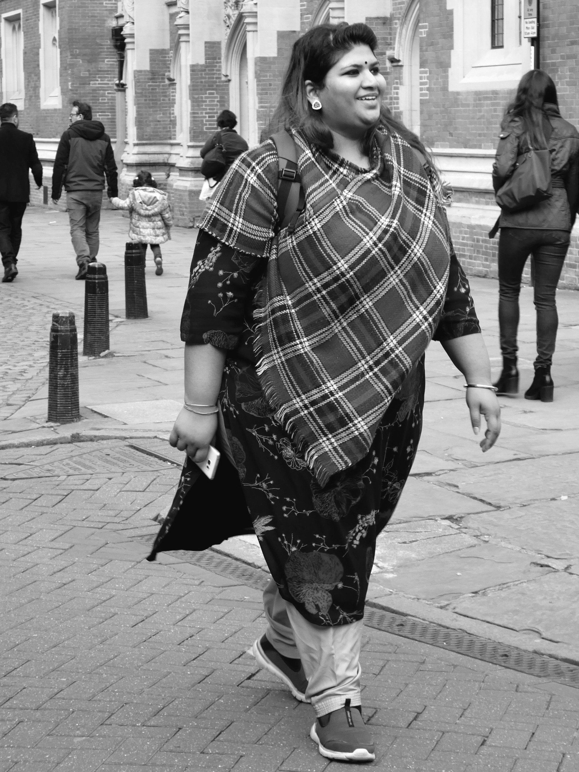 Photo by Derek Smith a woman striding down a cambridge street