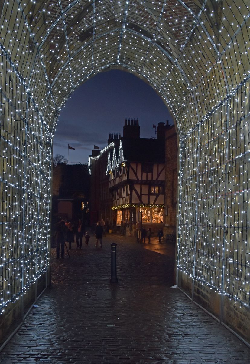 Night view of Lincoln through the cathedral arch