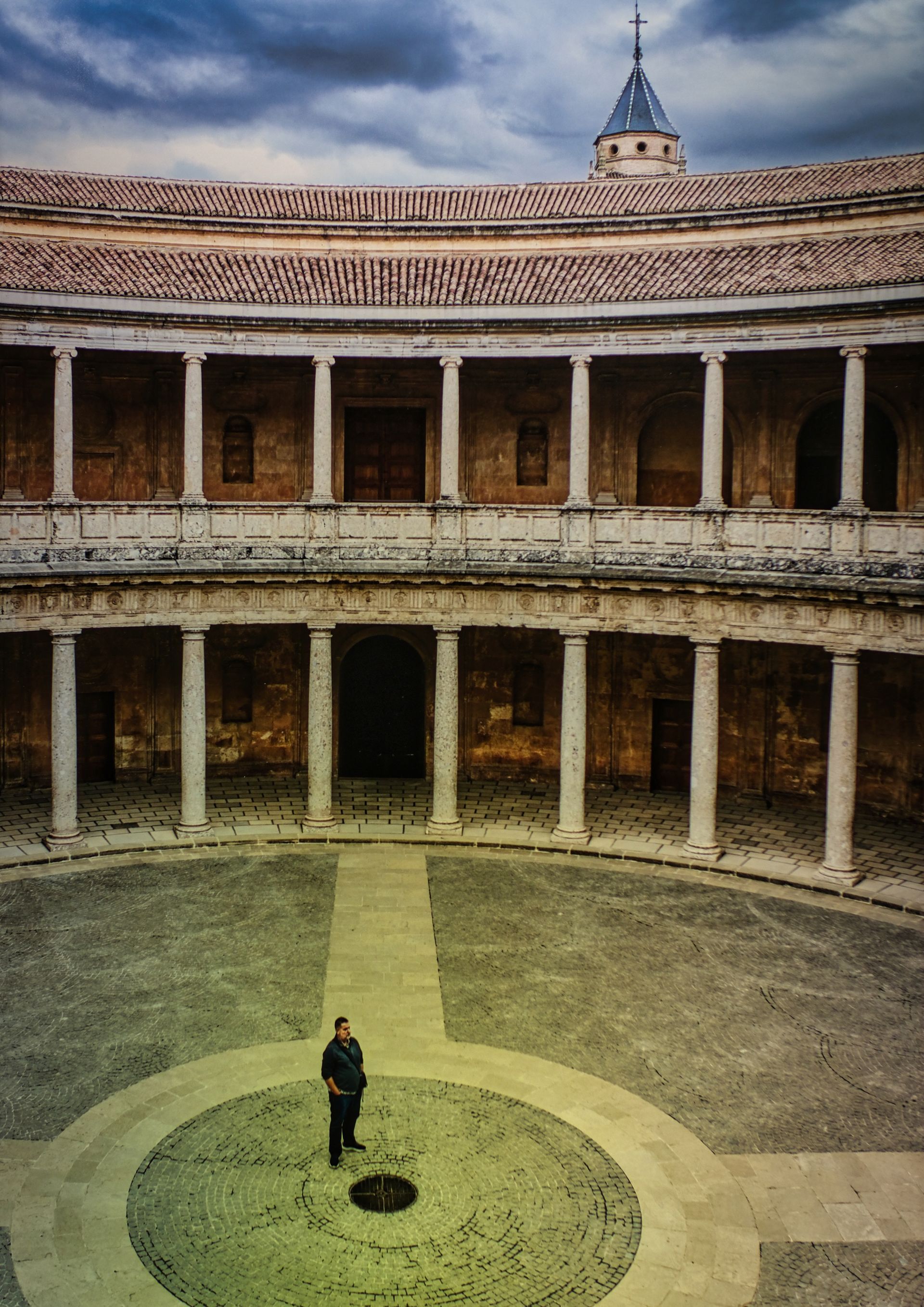 an Amphitheatre with a man in the centre