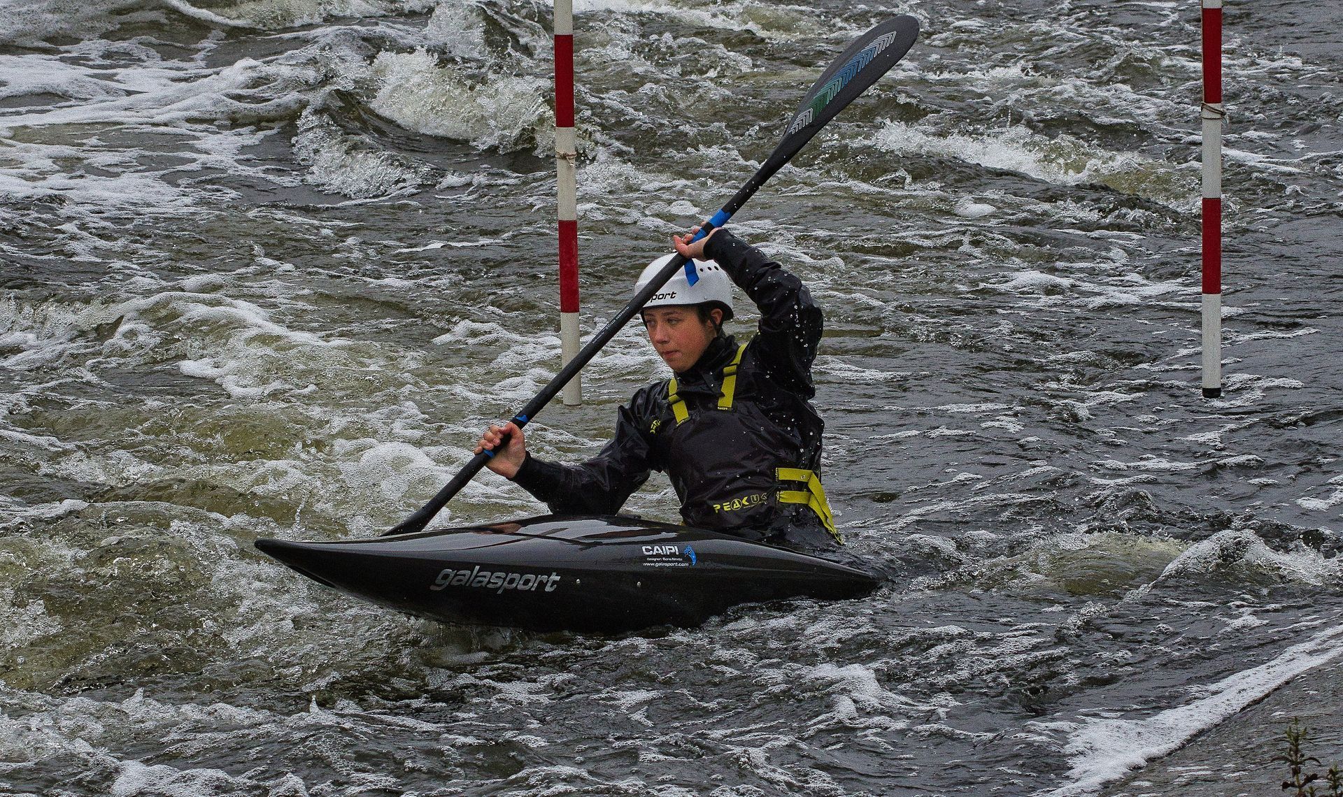 a kayak navigating a white water course