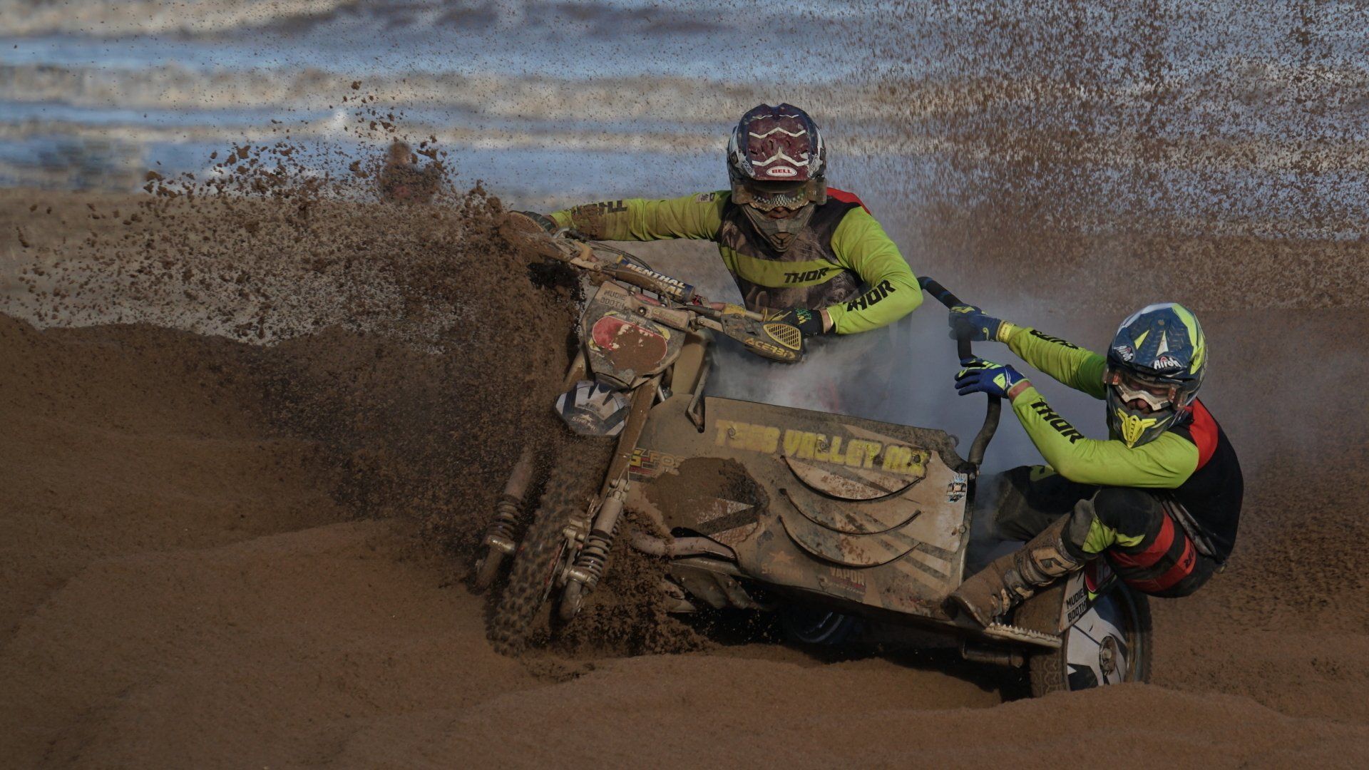 Sand Racing by: Derek Smith motorcycle and sidecar racing on a sandy beach