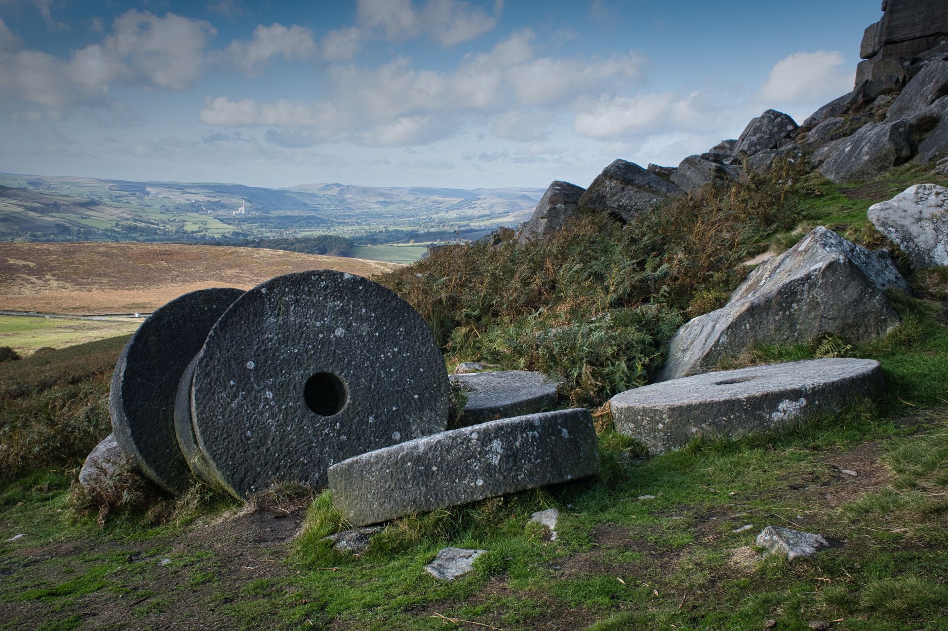 Millstones Above Castleton - by Derek Smith abandoned millstones on a hillside