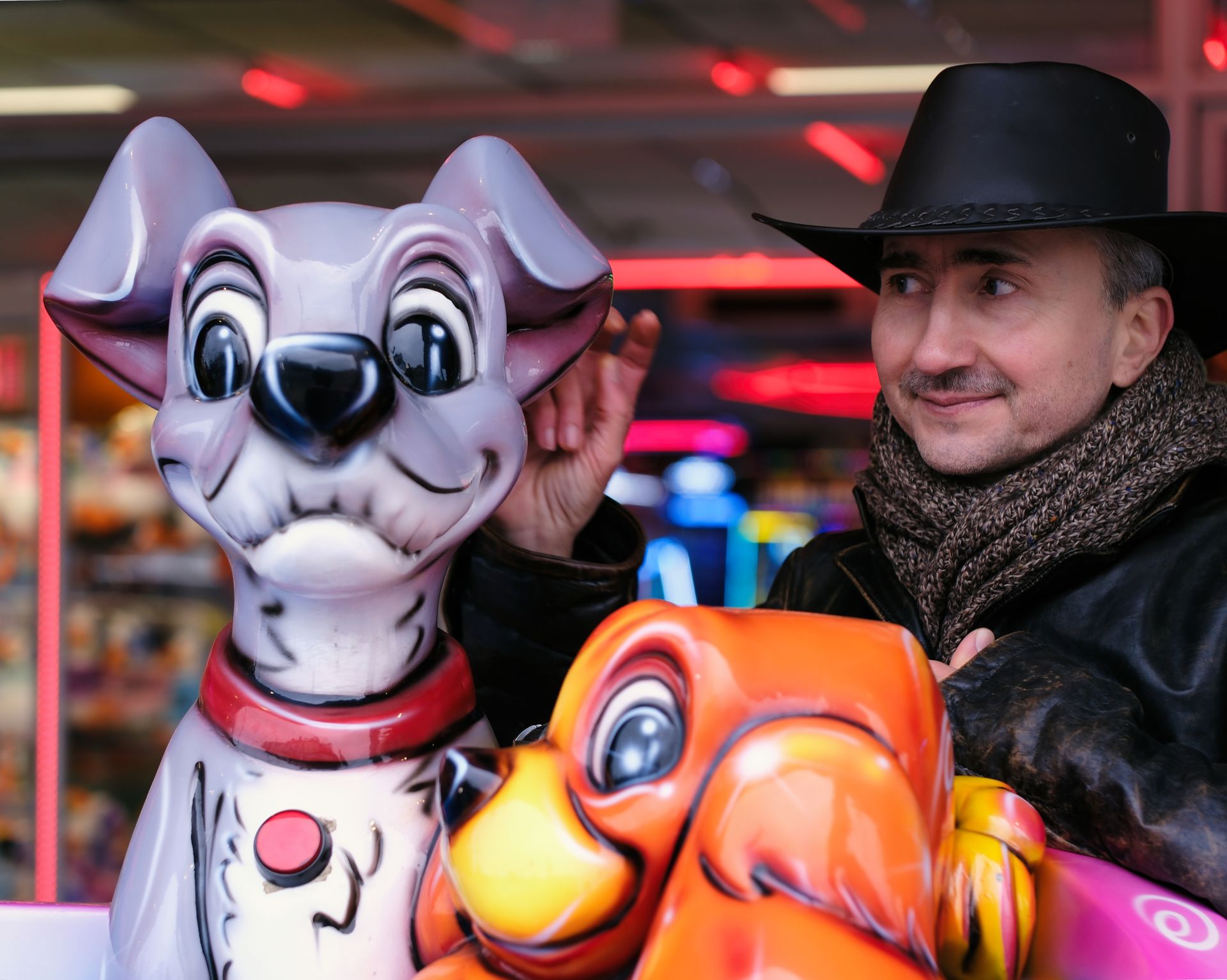 A male model interacting with a children's ride