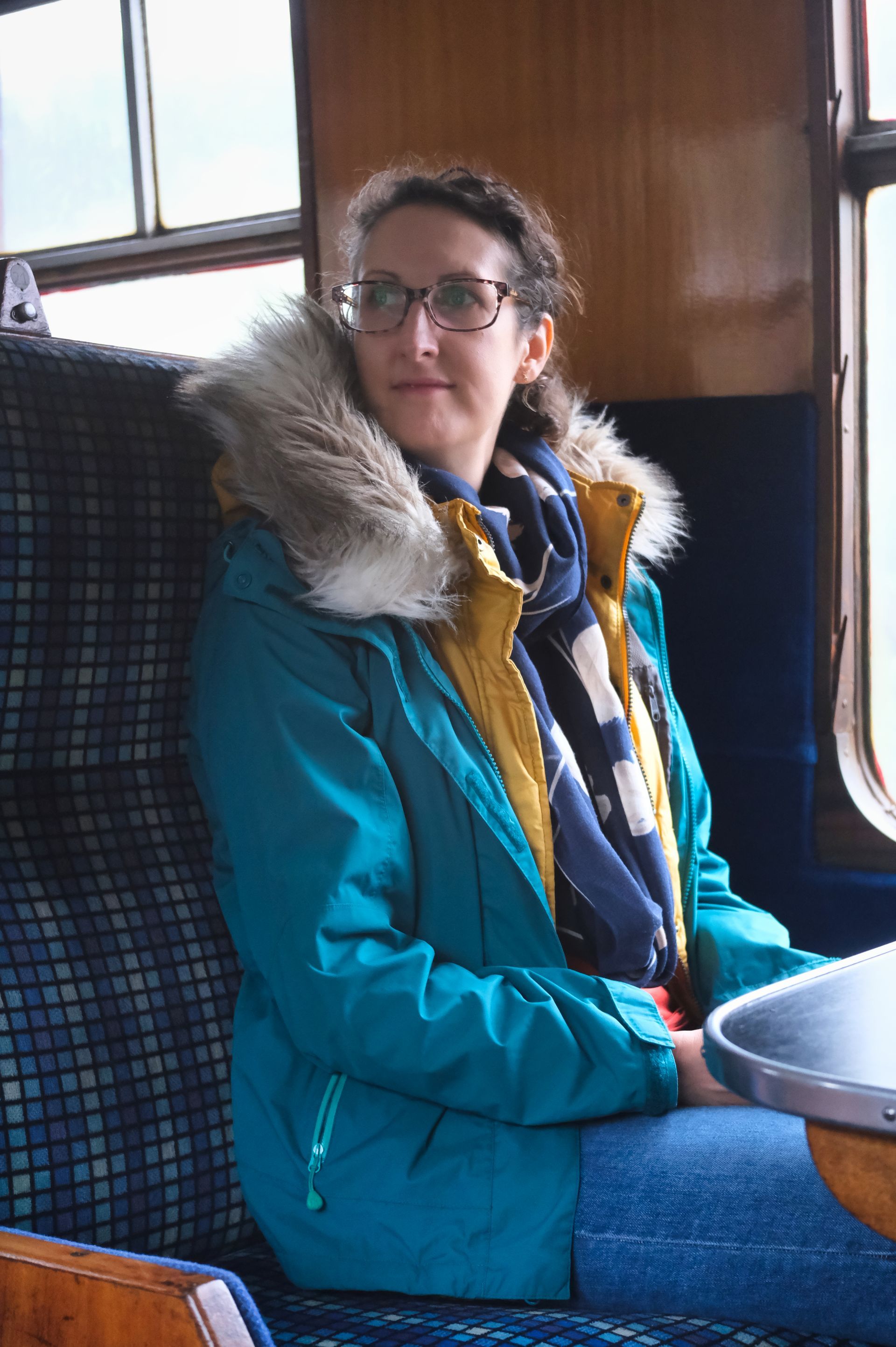 a girl sitting on a train