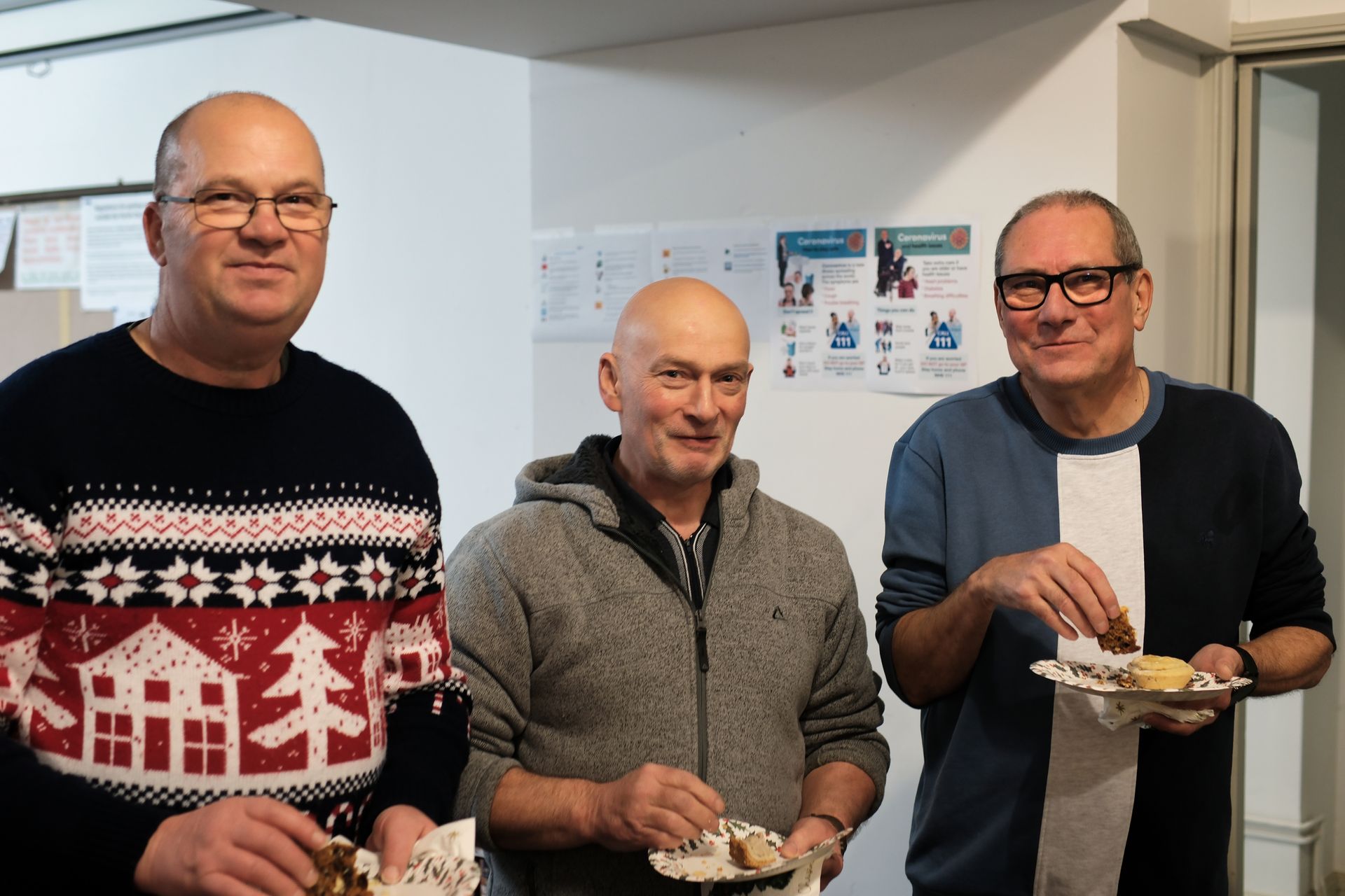 Three members socialising at a Christmas buffet