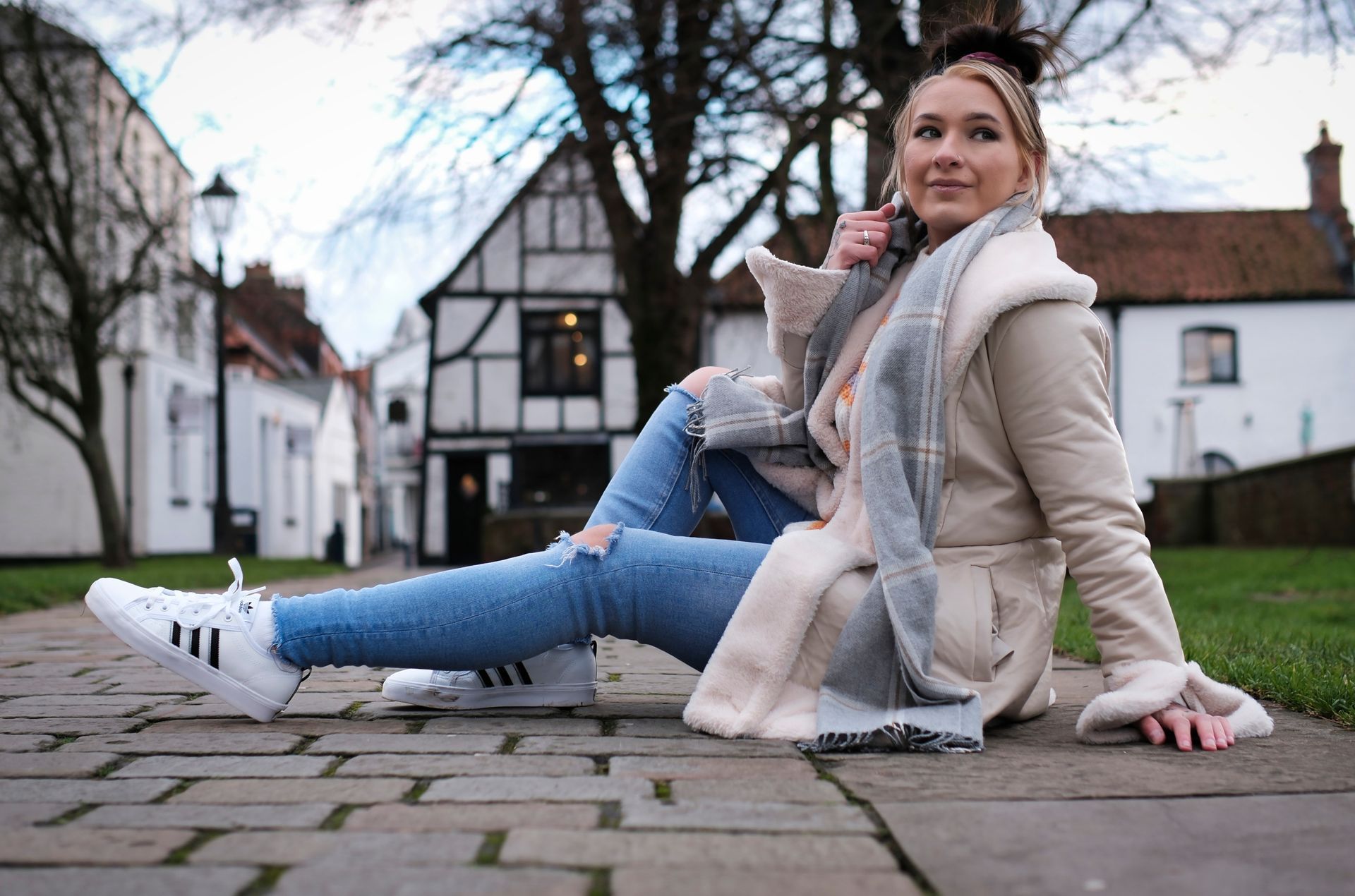 Louise by Derek Smith a fashion shot of a model sitting on the pavement