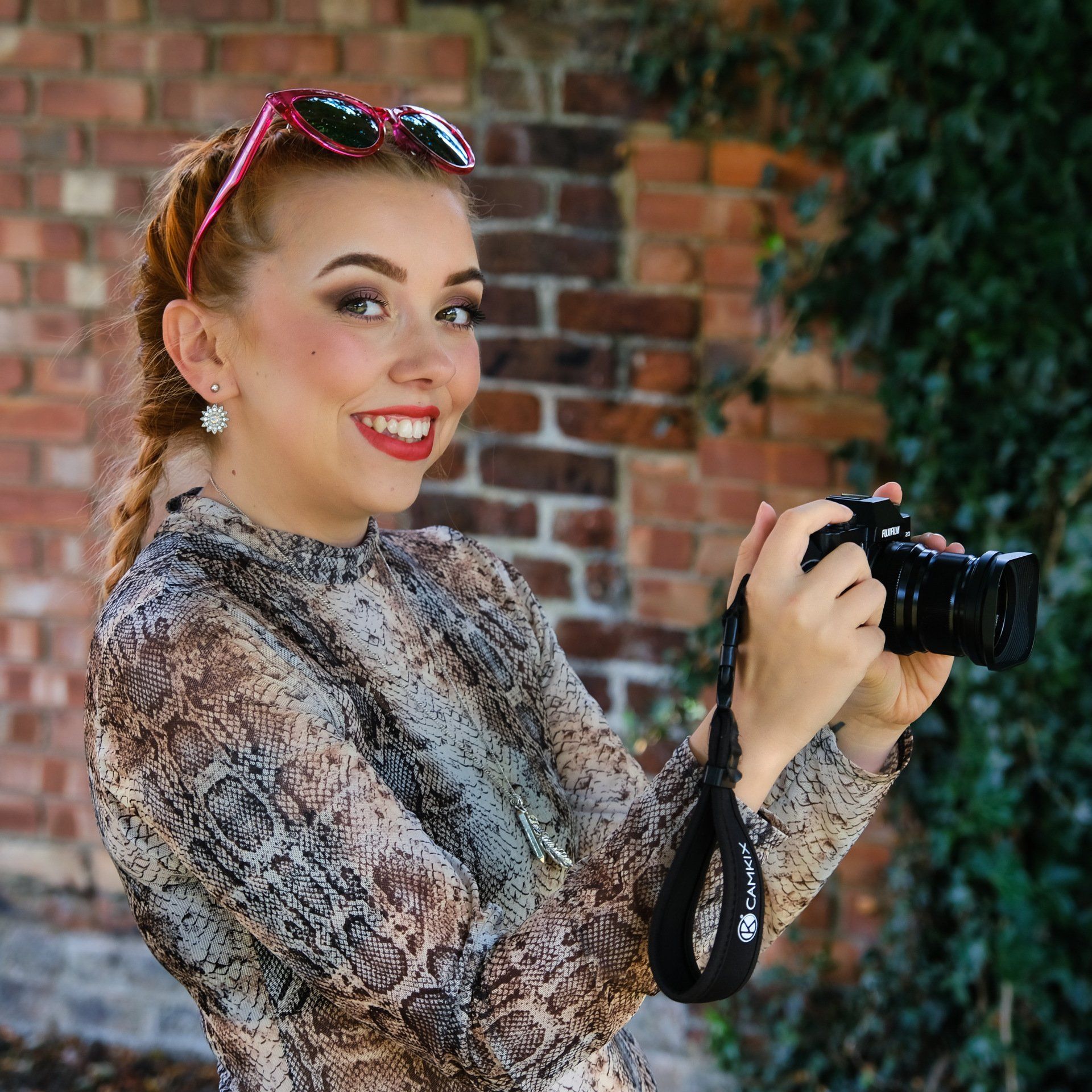 Taya by Derek Smith a female model posing with a camera