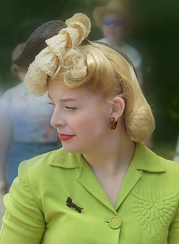 a portrait of a woman dressed in 1940s style