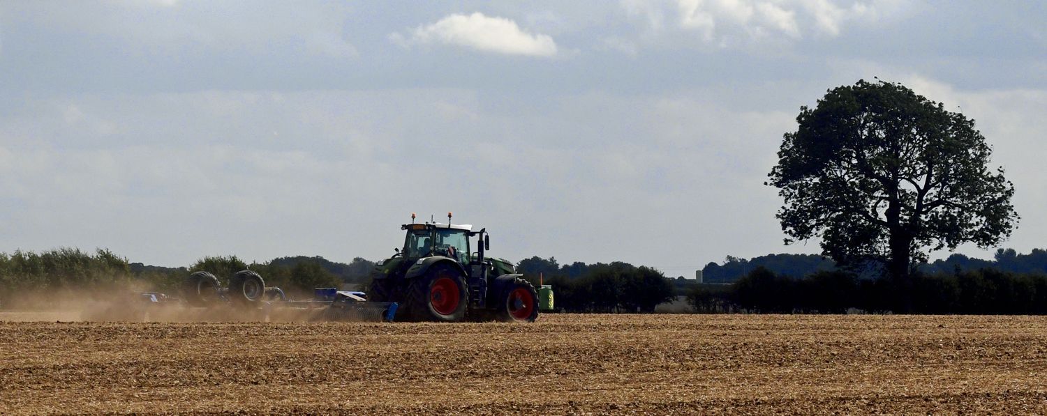 Dry Land by Graham Harrison a farm tractor preparinng a field