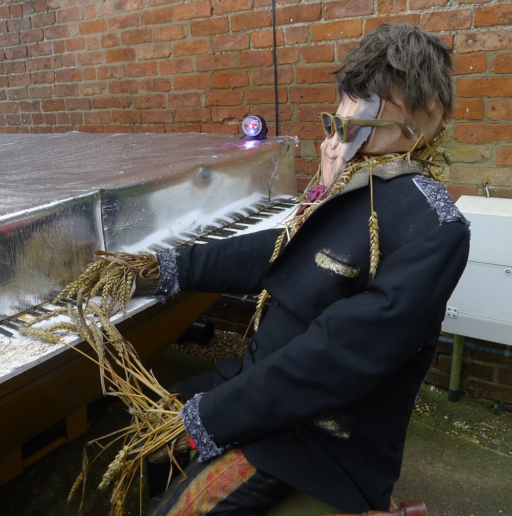 a village scarecrow as Elton John