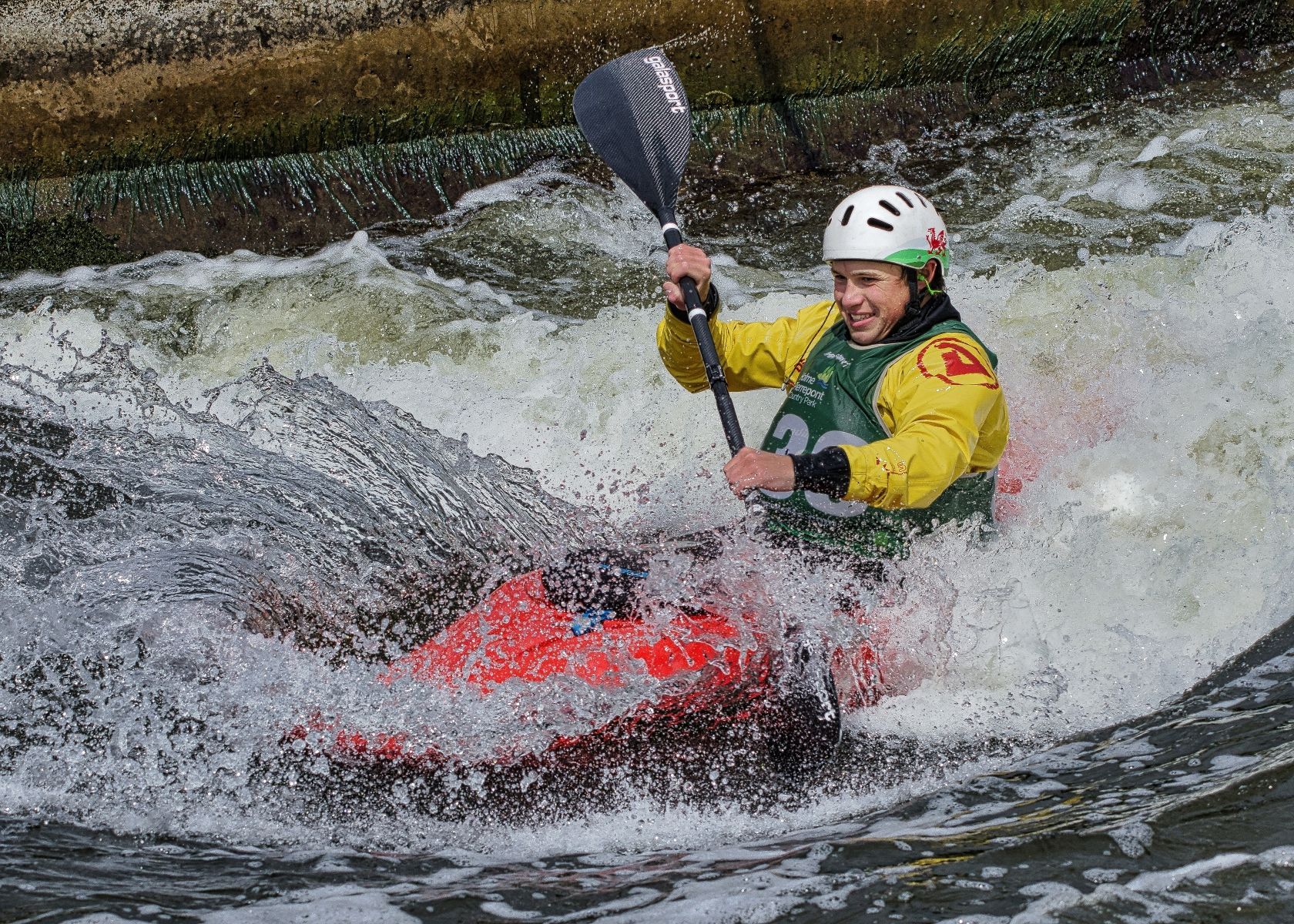 a man canoeing through rapids