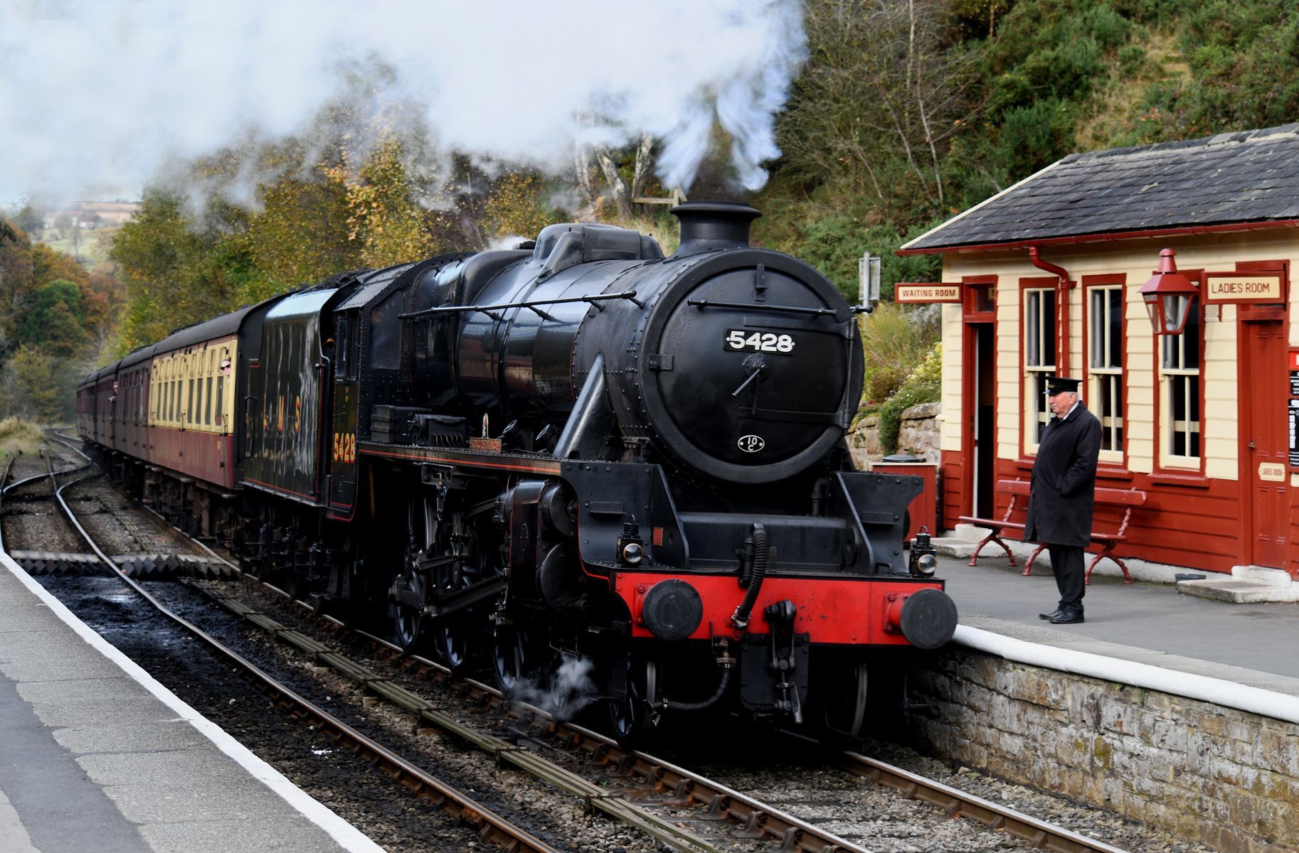 A heritage railway steam locomotive arriving at Goathland station