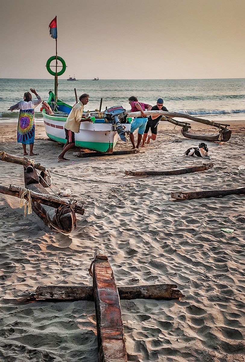 fishermen's boats being drawn up onto the beach