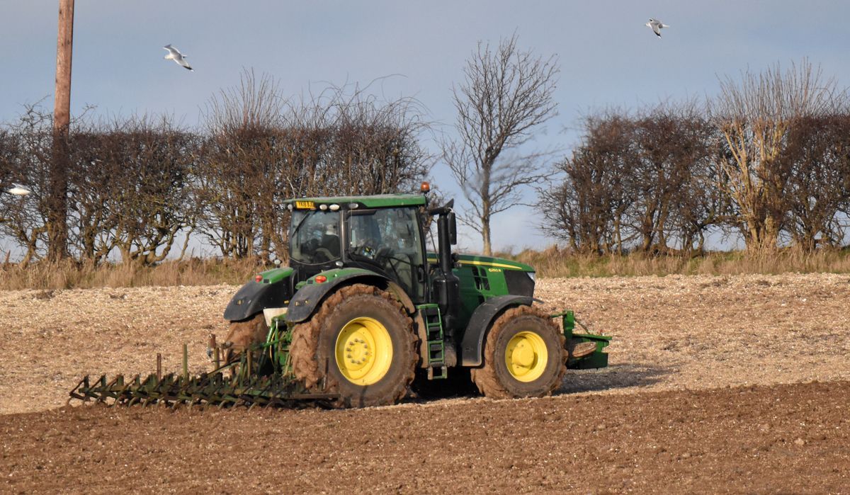 Farmers Have Started Early by Graham Harrison a farm tractor cultivating a field