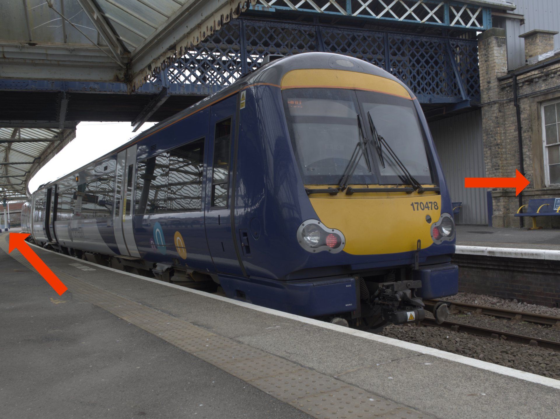 a photo of a train at a railway station platform