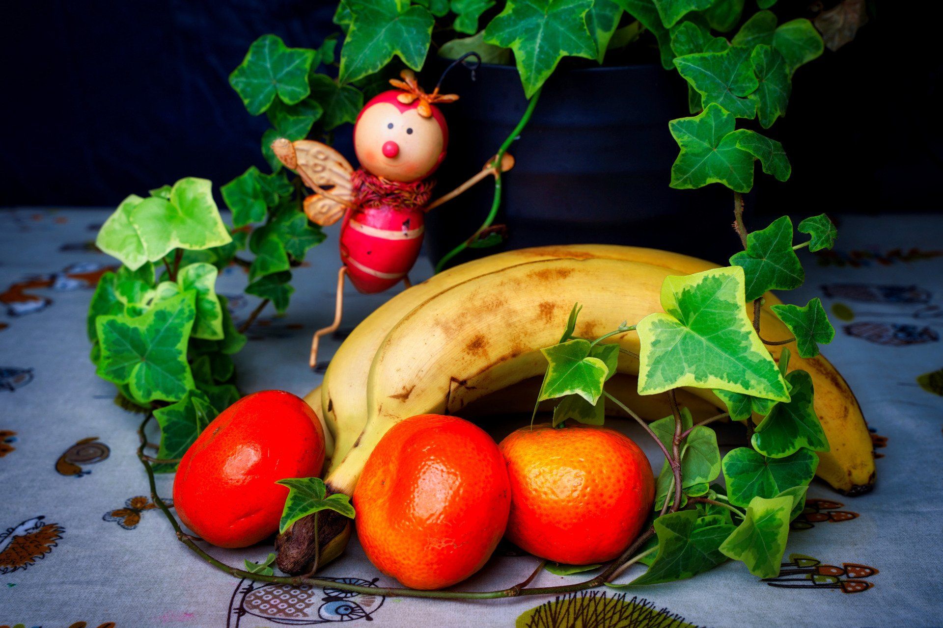 a table of fruit, and ivy